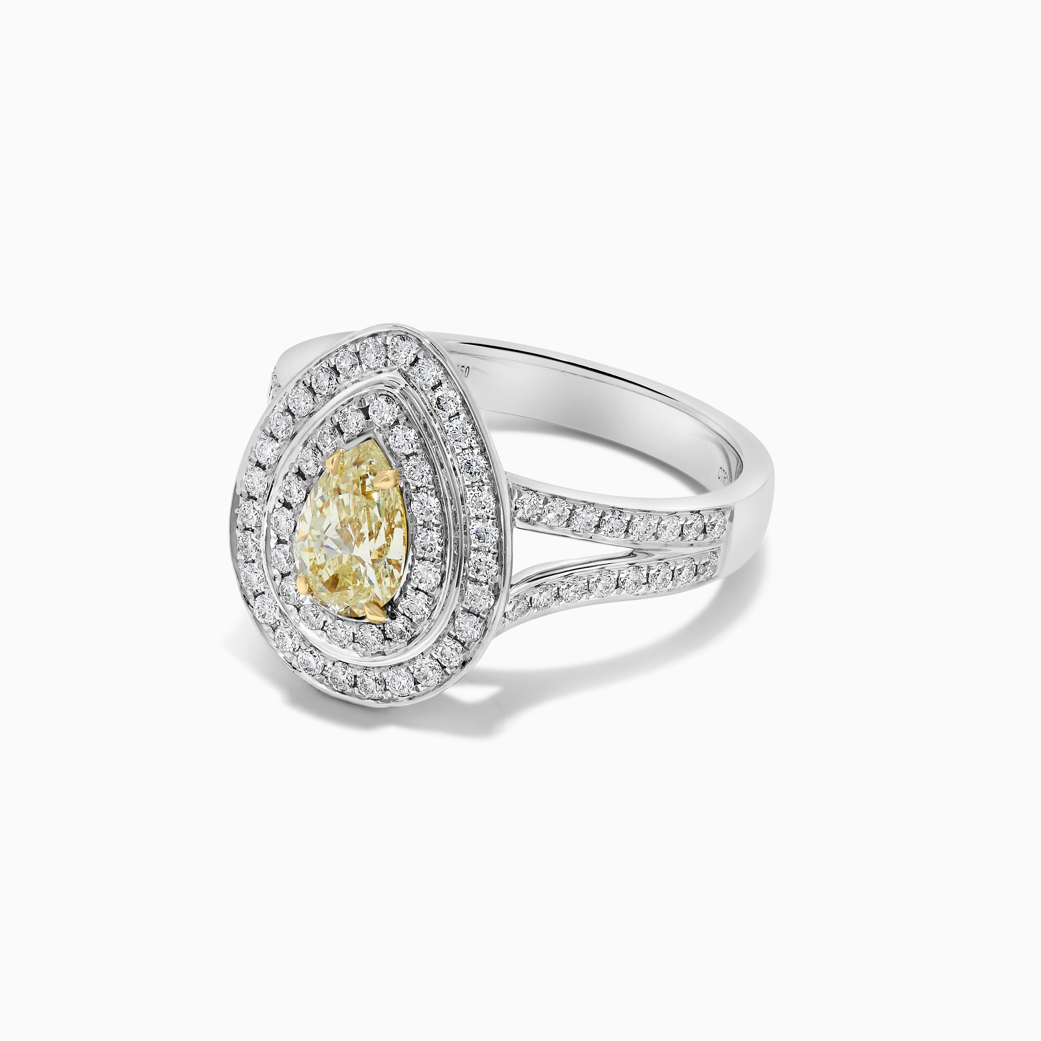 RareGemWorld's classic GIA certified diamond ring. Mounted in a beautiful 18K Yellow and White Gold setting with a natural pear cut yellow diamond. The yellow diamond is surrounded by small round natural white diamond melee. This ring is guaranteed