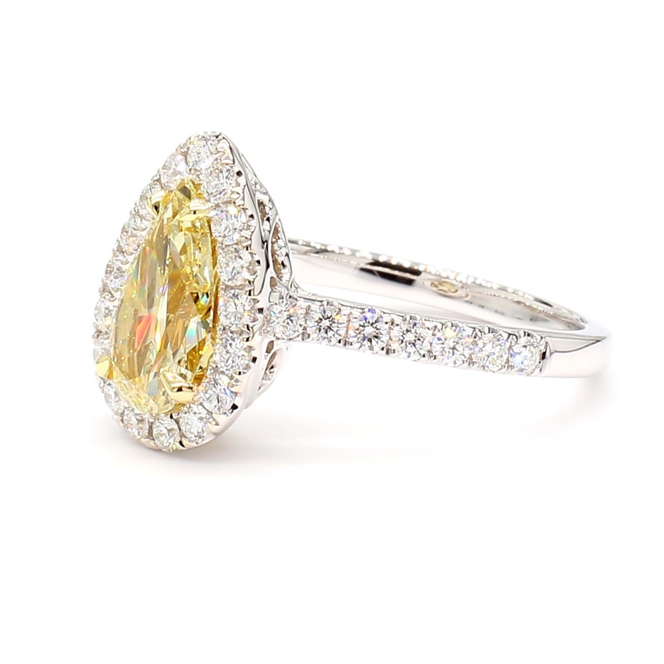 RareGemWorld's beautiful GIA certified diamond ring. Mounted in a beautiful 18K Yellow and White Gold setting with a natural pear cut yellow diamond. The yellow diamond is surrounded by small round natural white diamond melee. This ring is