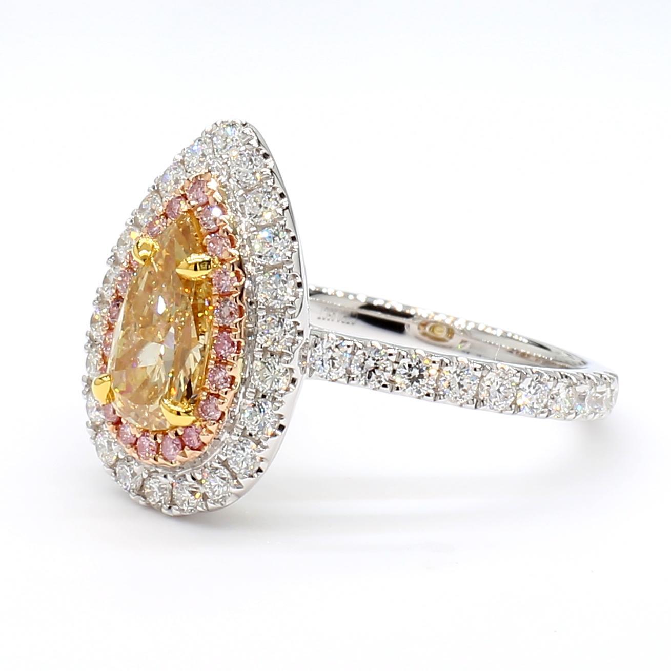 RareGemWorld's beautiful GIA certified diamond ring. Mounted in a beautiful 18K Rose and White setting with a natural pear cut fancy orangy yellow diamond. The diamond is surrounded by round cut natural white diamond melee and round natural pink