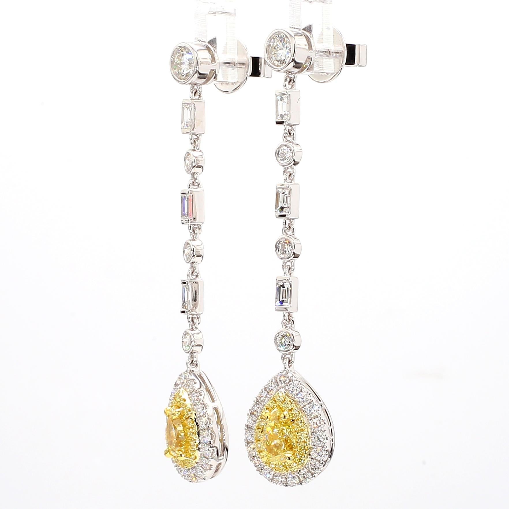 RareGemWorld's intriguing GIA certified diamond earrings. Mounted in a beautiful 18K Yellow and White Gold setting with natural pear cut yellow diamonds. The yellow diamonds are surrounded by natural baguette cut white diamonds, round natural white