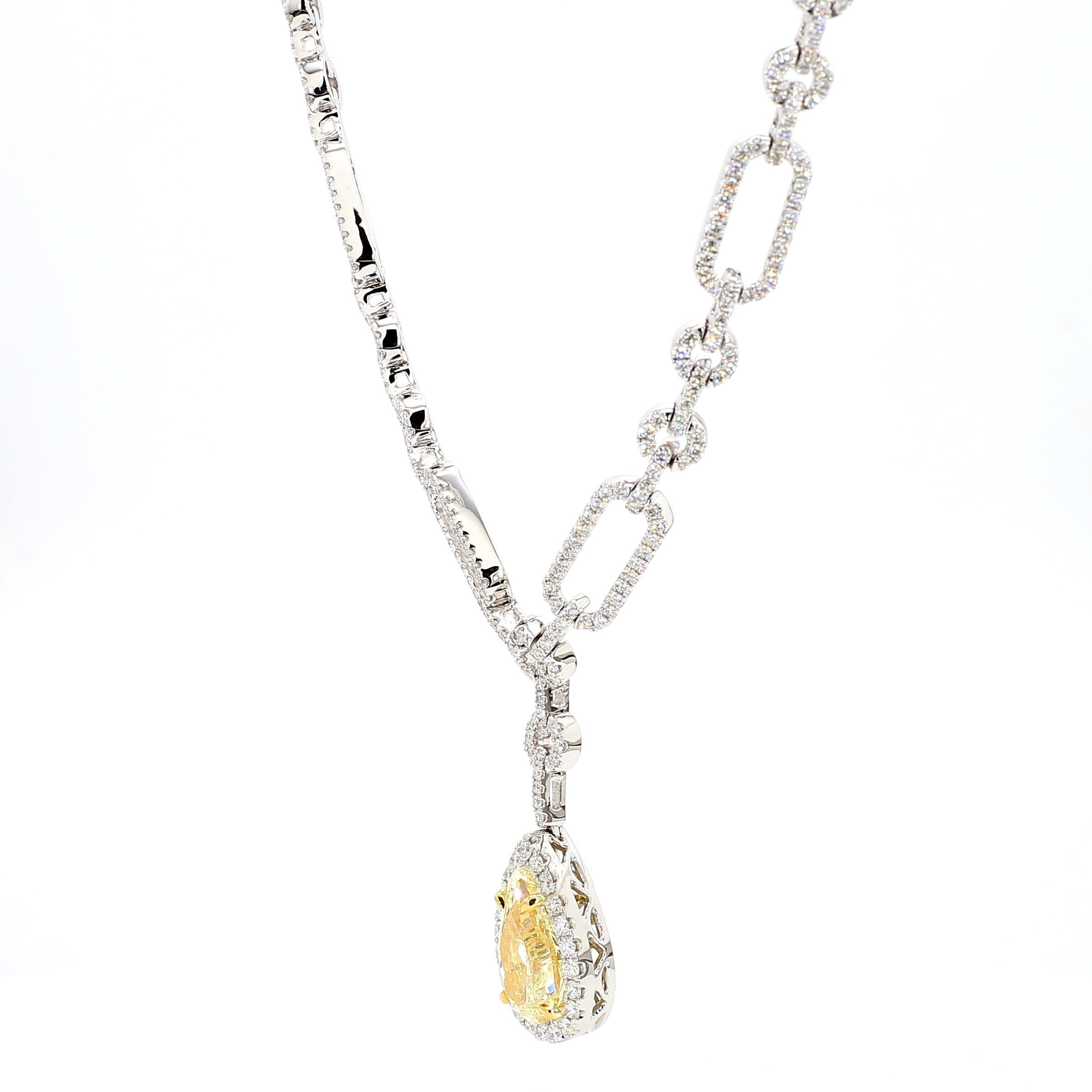 RareGemWorld's beautiful GIA certified diamond necklace. Mounted in a beautiful 18K Yellow and White Gold setting with a natural pear cut yellow diamond. The yellow diamond is surrounded by round natural white diamond melee. This necklace is