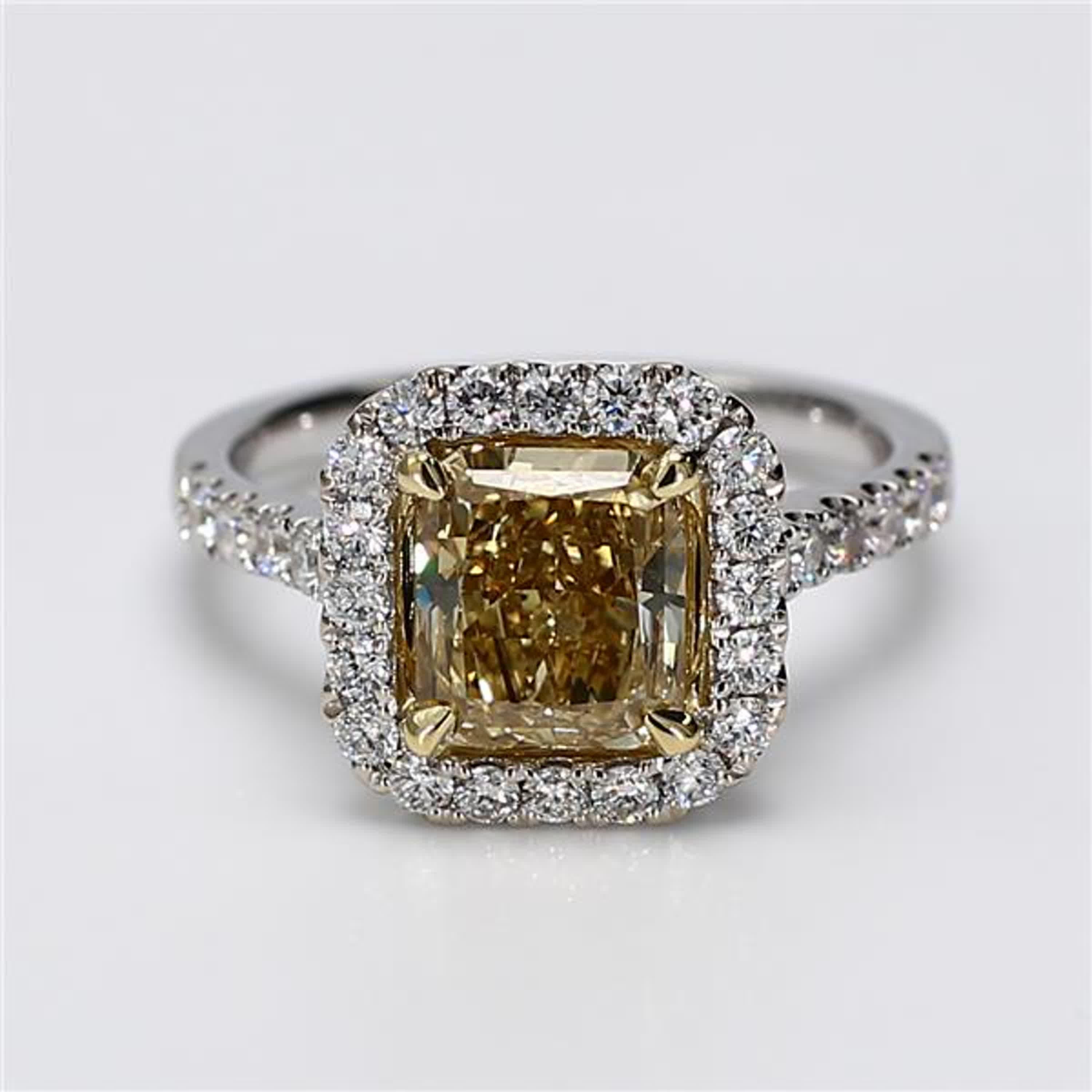RareGemWorld's classic diamond ring. Mounted in a beautiful 18K Yellow and White Gold setting with a natural radiant cut yellow diamond. The yellow diamond is surrounded by round natural white diamond melee. This ring is guaranteed to impress and