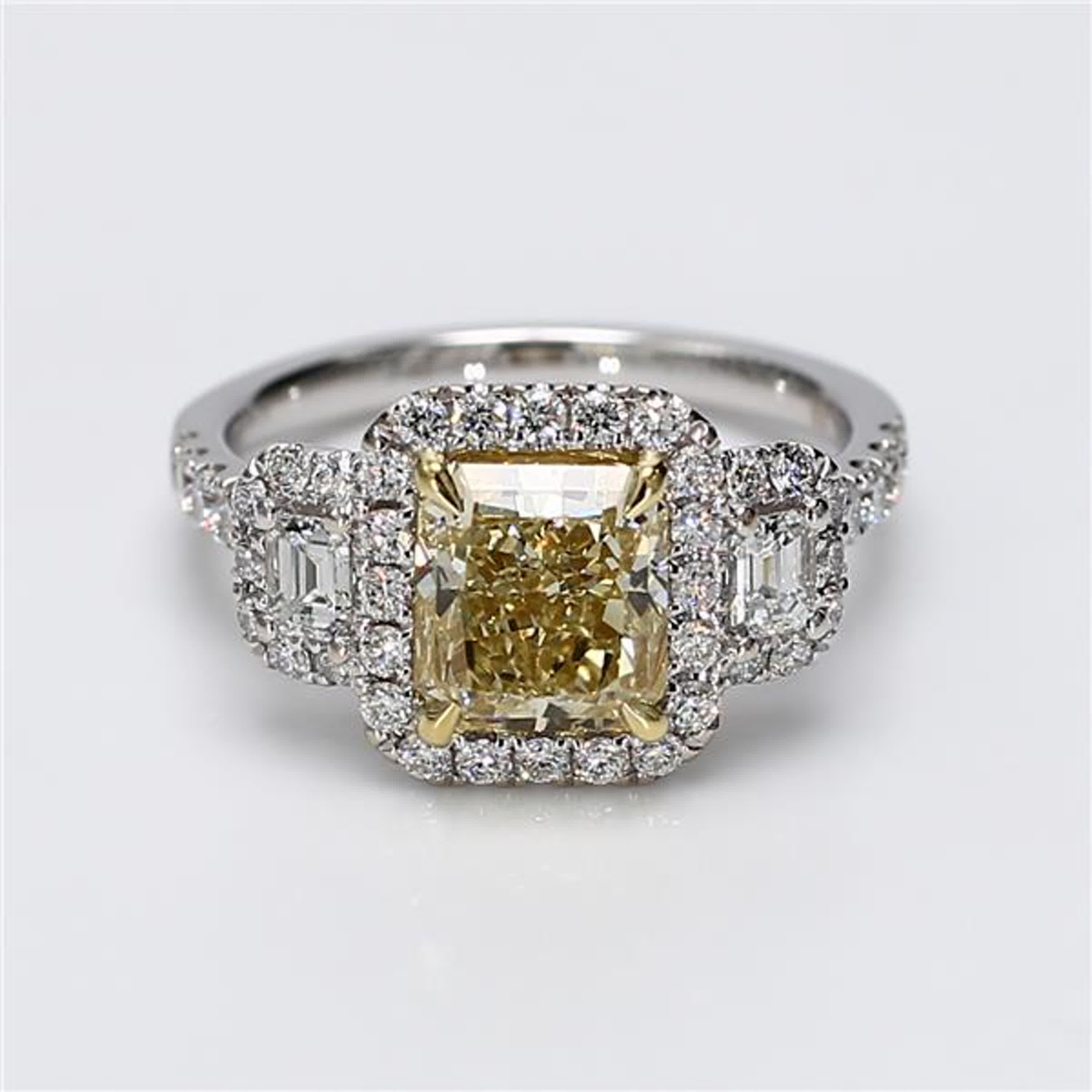 RareGemWorld's classic diamond ring. Mounted in a beautiful 18K Yellow and White Gold setting with a natural radiant cut yellow diamond. The yellow diamond is surrounded by natural emerald cut white diamonds and round natural white diamond melee.