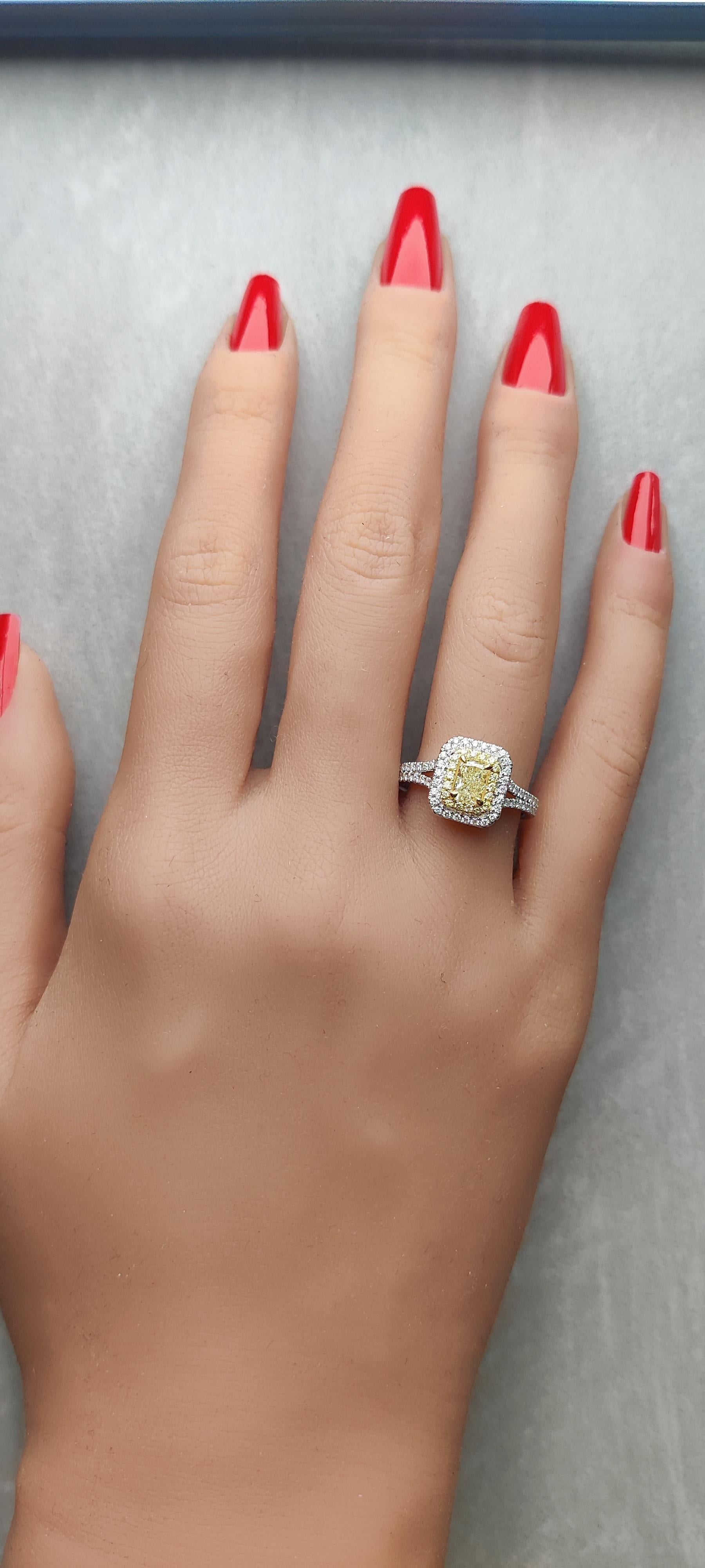 RareGemWorld's classic GIA certified diamond ring. Mounted in a beautiful 18K Yellow and White Gold setting with a natural radiant cut yellow diamond. The yellow diamond is surrounded by round natural yellow diamond melee and round natural white