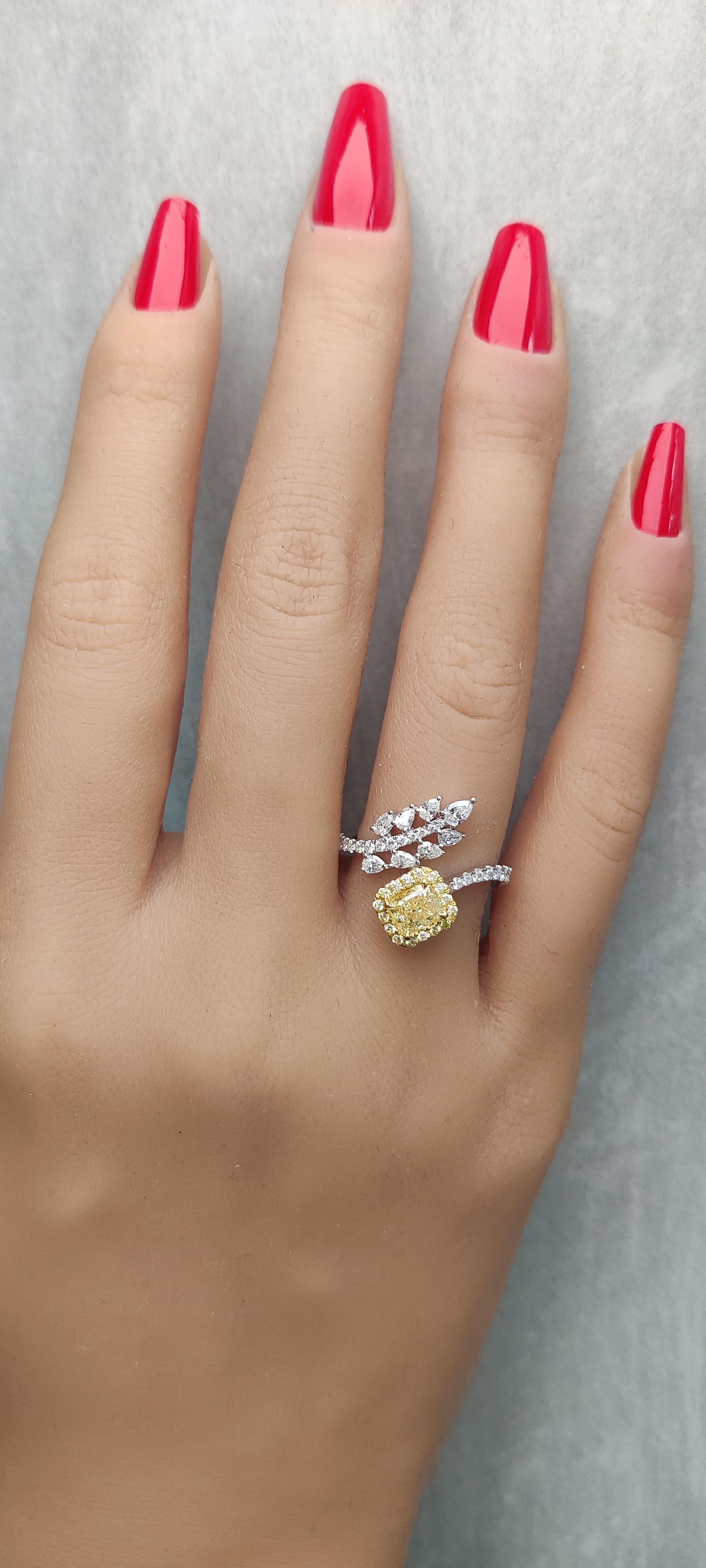 RareGemWorld's classic GIA certified diamond ring. Mounted in a beautiful 18K Yellow and White Gold setting with a natural radiant cut yellow diamond. The yellow diamond is surrounded by natural pear cut white diamonds, round natural yellow diamond