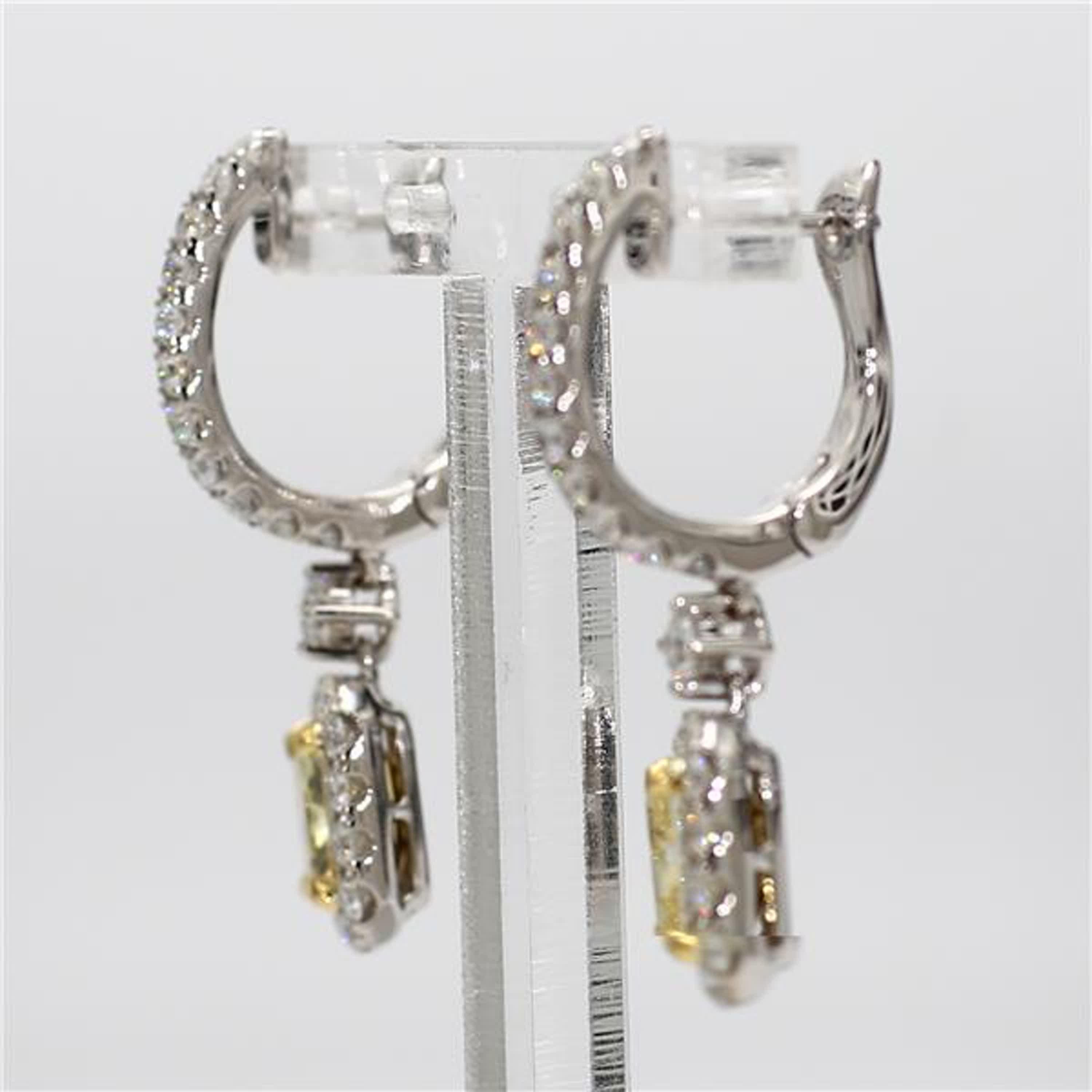 RareGemWorld's classic GIA certified diamond earrings. Mounted in a beautiful 18K Yellow and White Gold setting with natural radiant cut yellow diamonds. The yellow diamonds are surrounded by round natural white diamond melee. These earrings are