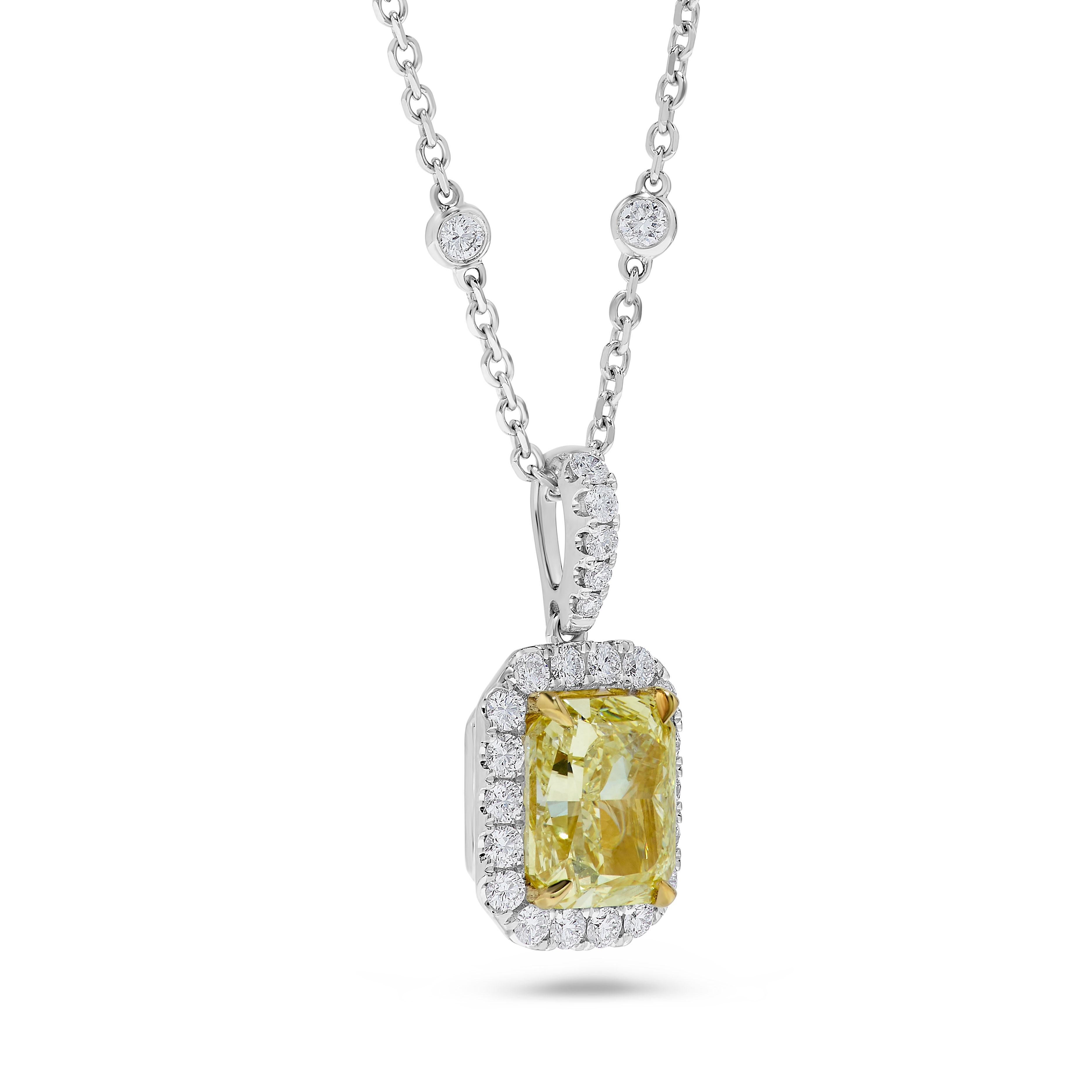 RareGemWorld's classic GIA certified diamond pendant. Mounted in a beautiful 18K Yellow and White Gold setting with a natural radiant cut yellow diamond. The yellow diamond is surrounded by round natural white diamond melee. This pendant is