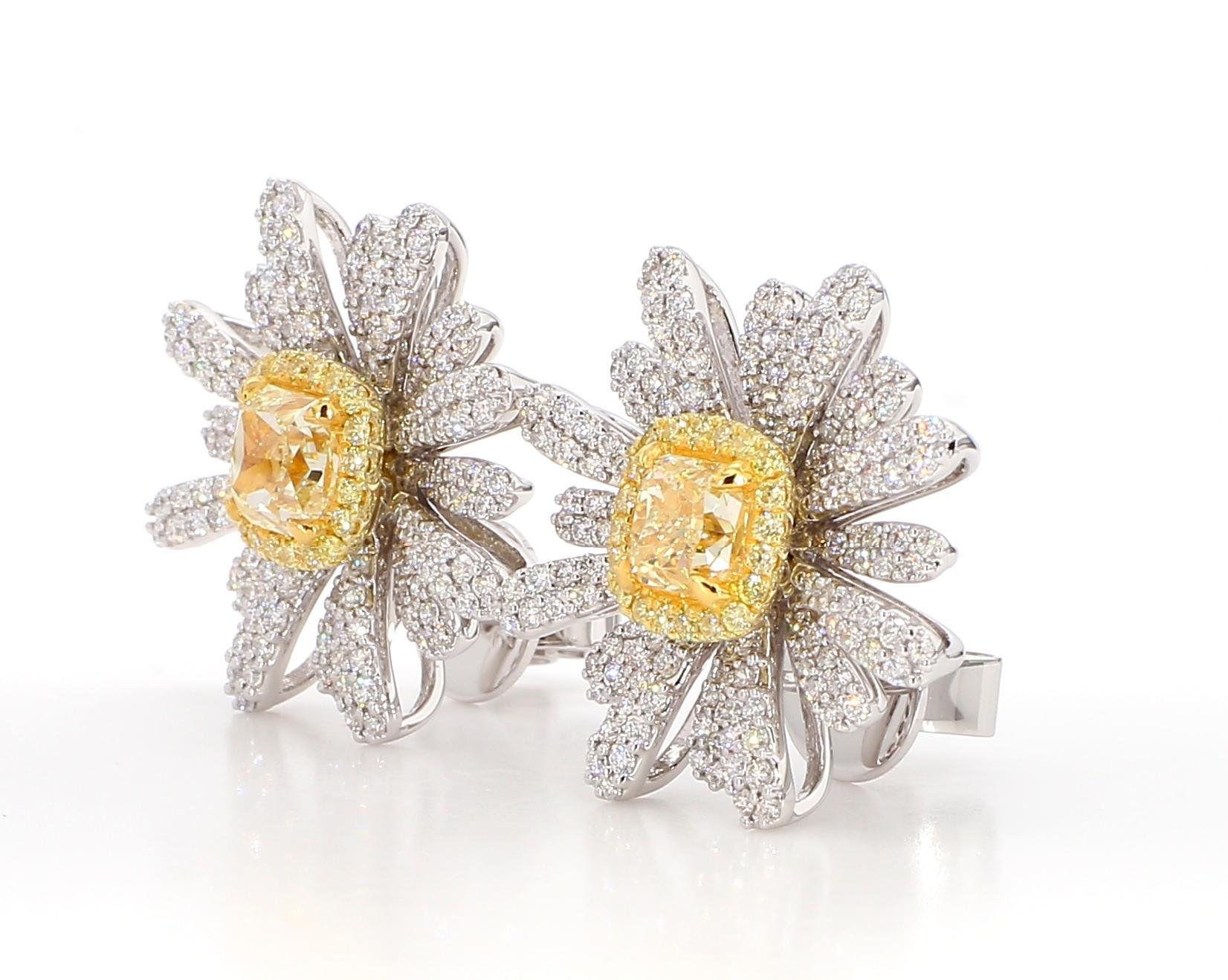 RareGemWorld's GIA certified beautiful diamond earrings. Mounted in a beautiful 18K Yellow and White Gold setting with natural radiant cut yellow diamonds. The yellow diamonds are surrounded by round natural white diamond melee and round natural