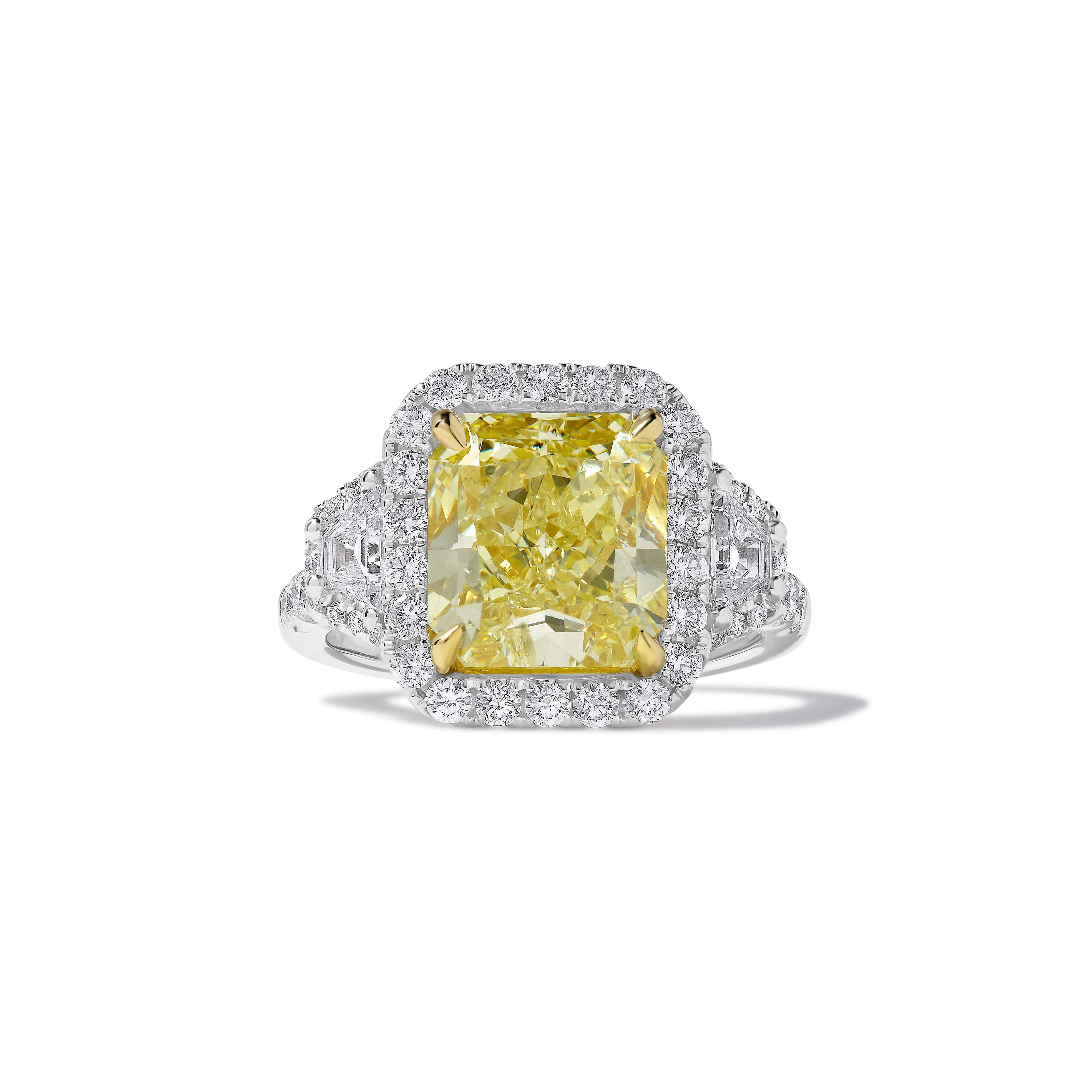 RareGemWorld's classic GIA certified diamond ring. Mounted in a beautiful 18K Yellow and White Gold setting with a natural radiant cut yellow diamond. The yellow diamond is surrounded by natural taper baguette cut white diamonds and round natural