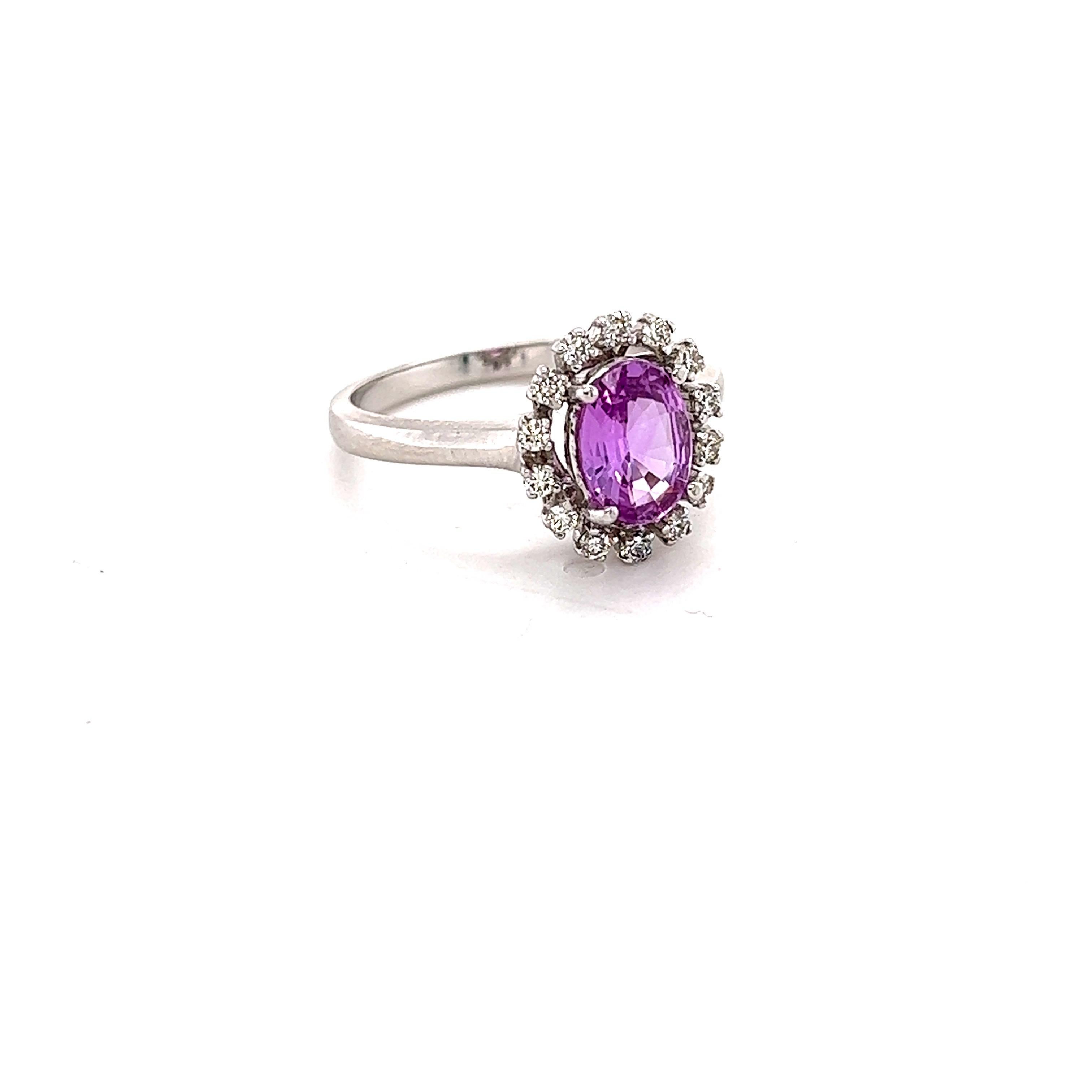 This beautiful ring has a Natural Oval Cut Pink Sapphire that weights 1.09 Carats. The pink sapphire measures at approximately 8 mm x 6 mm. 

The ring is embellished with 14 Round Cut Diamonds that weigh 0.21 Carats with a clarity and color of VS/H.