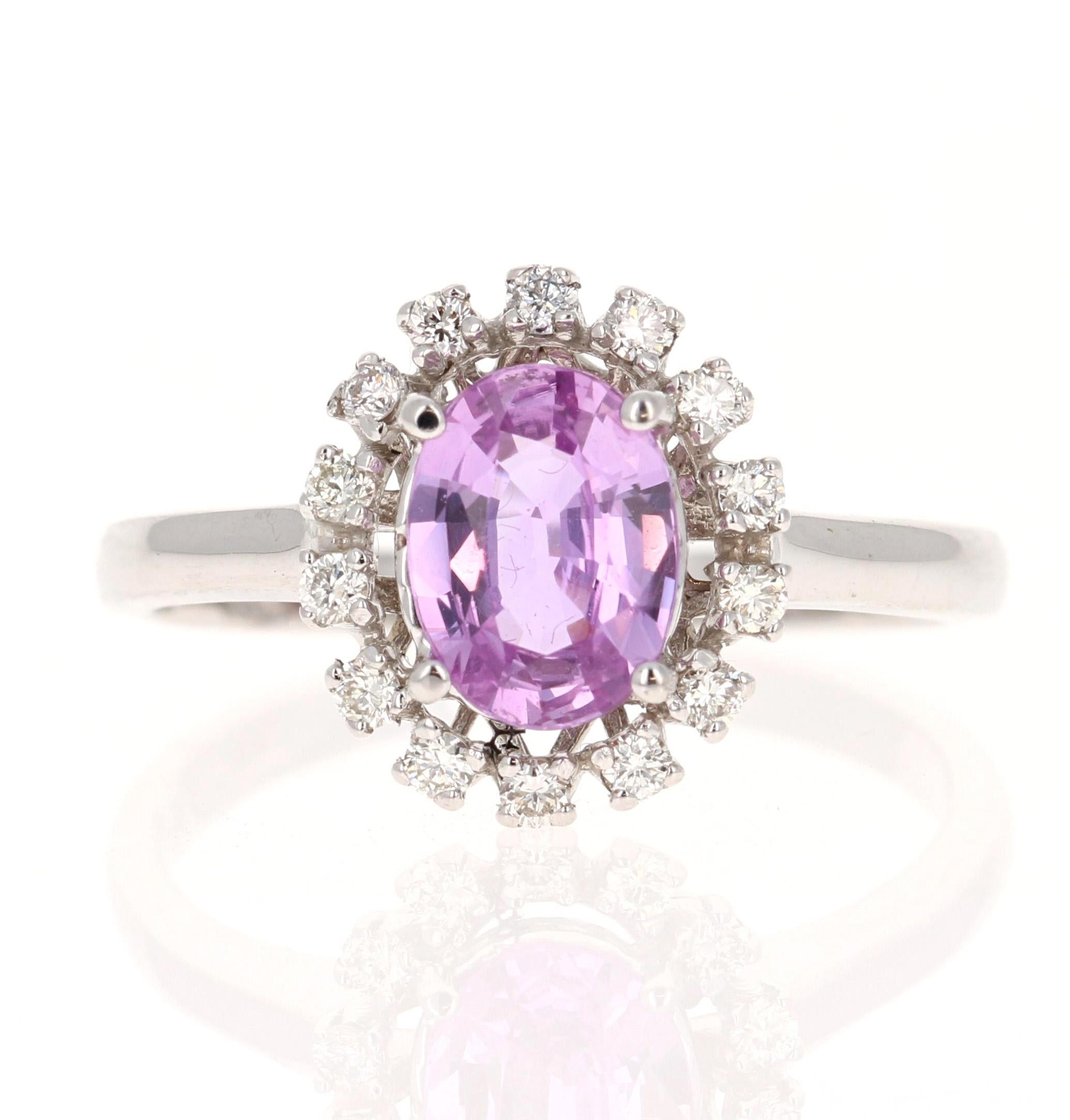 This beautiful ring has a Natural Oval Cut Pink Sapphire that weights 1.09 Carats. The pink sapphire measures at approximately 8 mm x 6 mm. 

The ring is embellished with 14 Round Cut Diamonds that weigh 0.21 Carats with a clarity and color of VS/H.