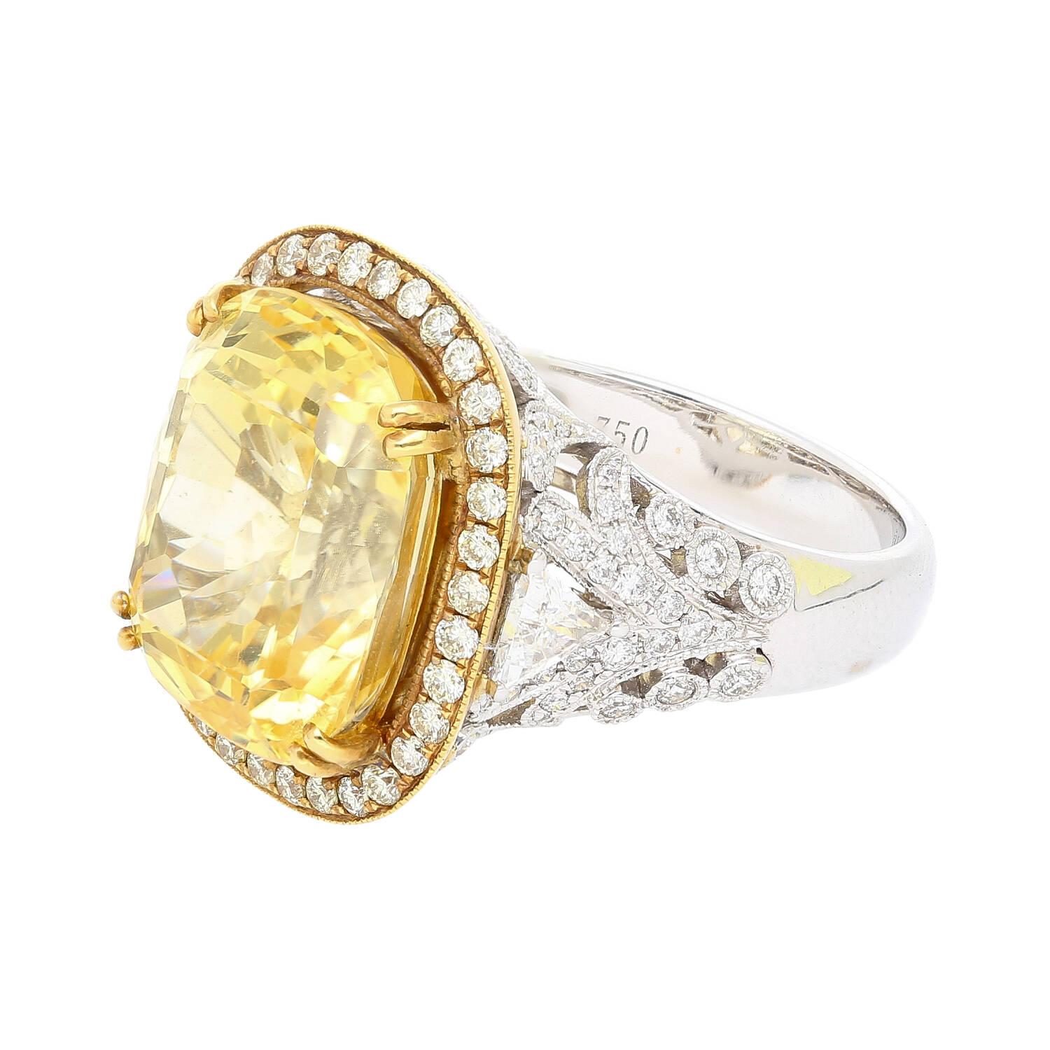 Discover unparalleled elegance with this regal 17-carat cushion cut no-heat yellow sapphire and trillion cut diamond 18k white gold ring. A true masterpiece.

The GIA-certified sapphire captivates with its vivid yellow color and brilliance, a