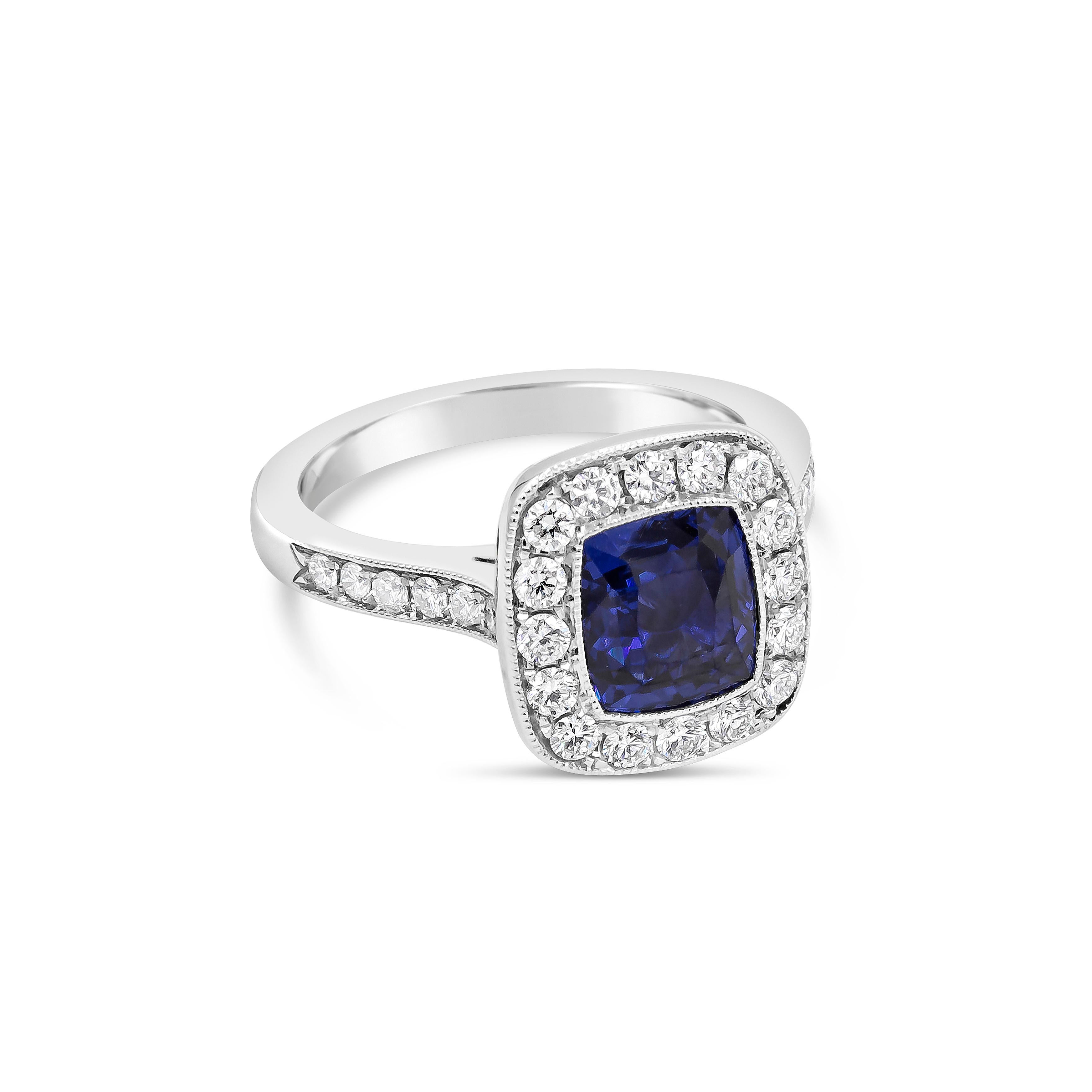 Showcasing a 2.11 carat cushion cut blue sapphire that GIA certified as BLUE color with no indications of heat treatment. Surrounding the sapphire is a row of round brilliant diamonds, in a diamond encrusted mounting made in platinum. Accent