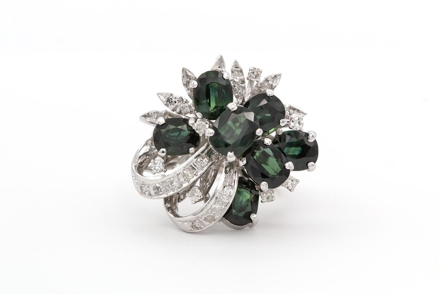 We are pleased to offer this GIA Certified No Heat Green-Blue Sapphire & Diamond 18k White Gold Cocktail Cluster Ring. This finely crafted piece features a cluster/ribbon design set with an estimated 8.00ctw GIA certified oval cut green-blue