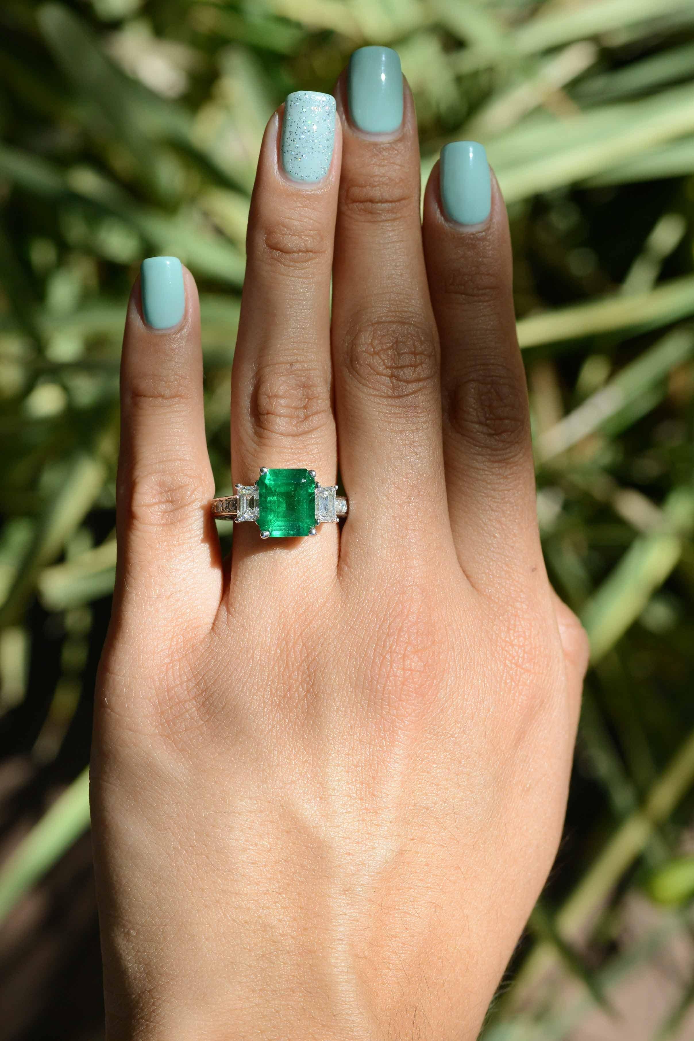 A contemporary emerald engagement eternity ring. Certified by GIA, the Gemological Institute of America as 4.13 carats. The report stating natural emerald with no oil treatment making this fabulous gemstone even more of a rarity. Set in 18k white