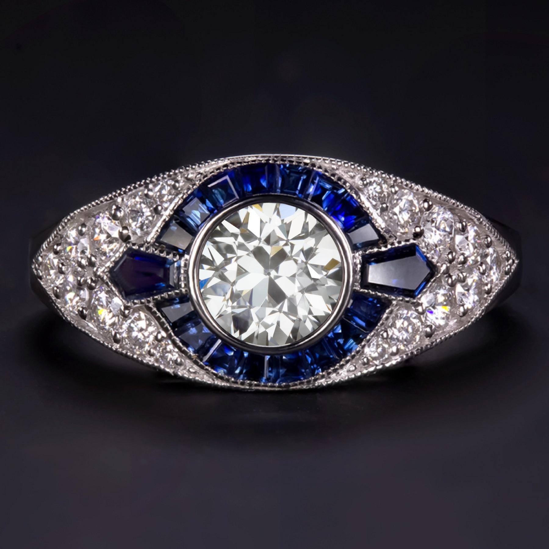 This timeless diamond blue sapphire cocktail ring combines bright sparkle, rich color, and a romantic design.

The main stone is an old transitional cut GIA certified diamond has bright white F color, a completely eye clean, lively sparkle, and