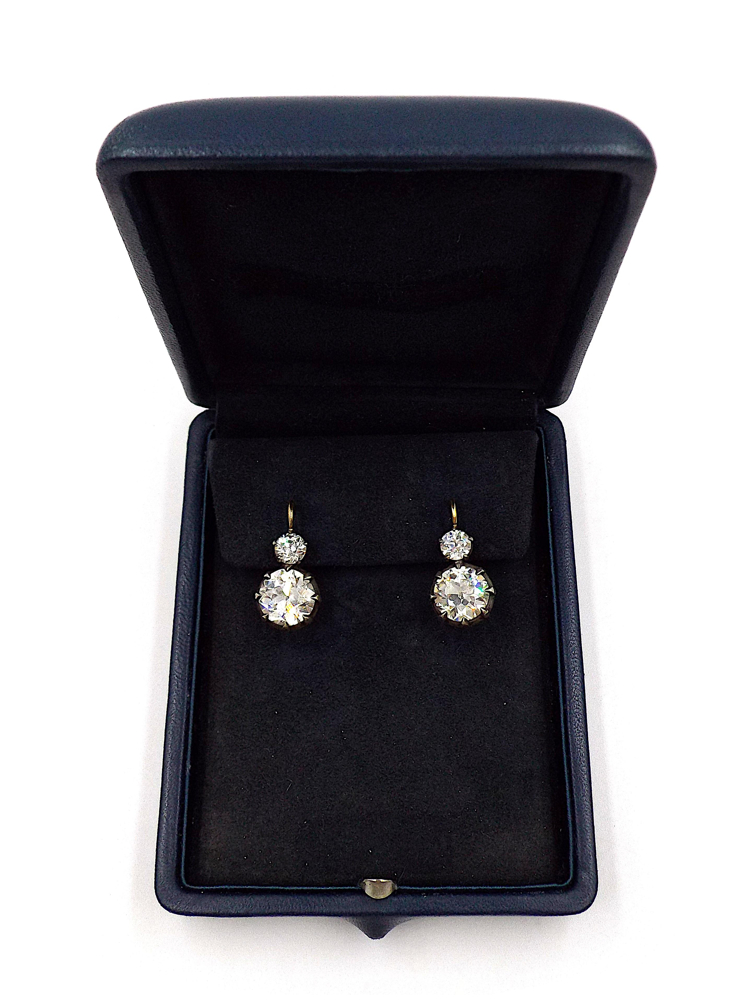 A pair of elegant earrings featuring two old European cut diamonds weighing 3.03ct and 3.42ct. The upper stones weigh 1.21ct in total. Accompanied by two GIA certificates stating that the diamonds weighing 3.03ct and 3.42ct are of N color VS1