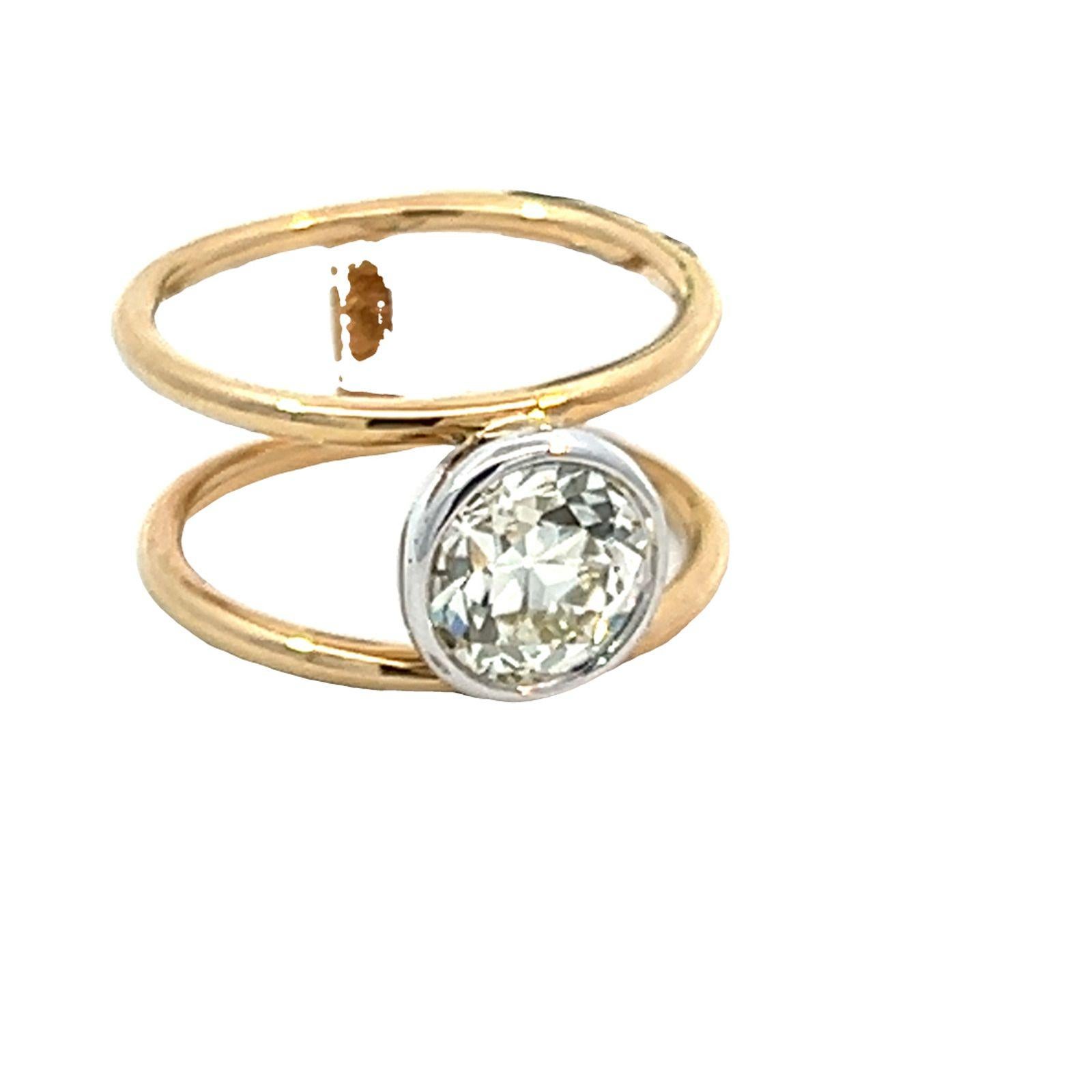 GIA-certified old European cut diamond set with a 14K double yellow gold band. The diamond weighs 1.87 carats is N color and VS2 clarity. 
The ring is crafted in 14-karat yellow and white gold. The old European cut diamond is bezel set in 14karat