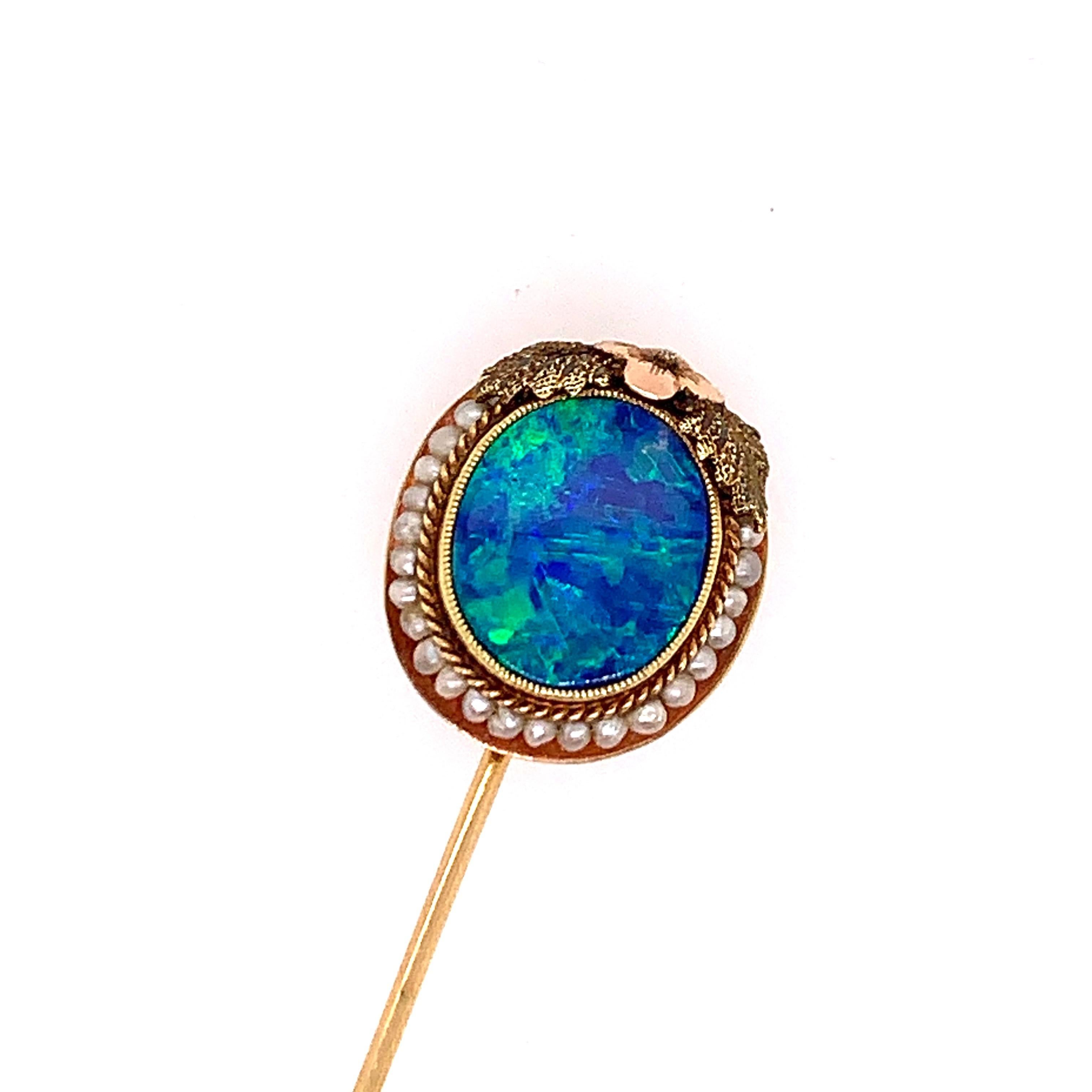 A vintage GIA certified natural opal doublet pin consisting of a natural opal on top and a natural opal on the back. The color change of green and blue is spectacular...a one of a kind. It is set with pearls and has a beautiful floral design. Listed