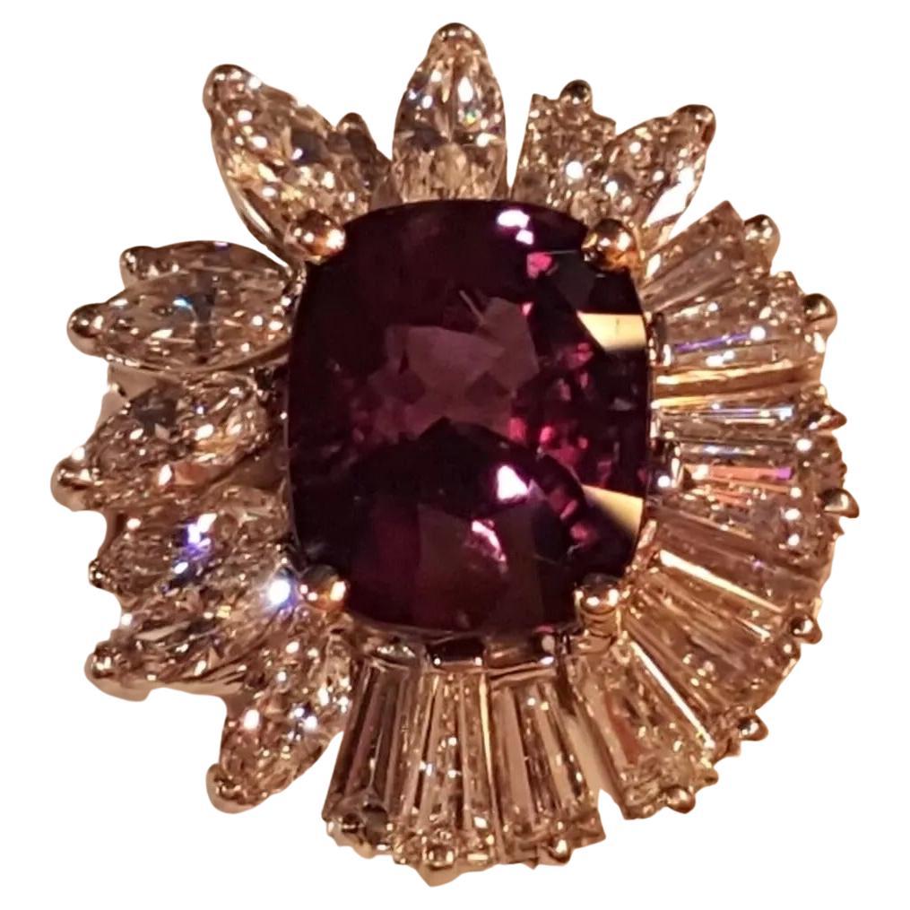 Oscar Heyman Alexandrite Diamond engagement ring is an impressive piece of jewelry featuring a 6.04 ct natural cushion cut Alexandrite known for its vibrant color change from blue-green to reddish purple, a highly desirable quality in Alexandrite.