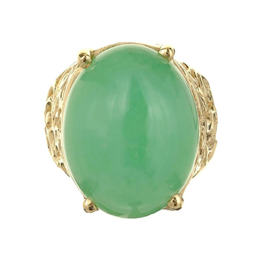 1950's GIA certified cabochon Jadeite Jade natural green gold cocktail ring, is a masterpiece that captures the essence of timeless elegance. This exquisite ring boasts a lush oval cabochon jadeite jade center stone, seamlessly set in a luxurious