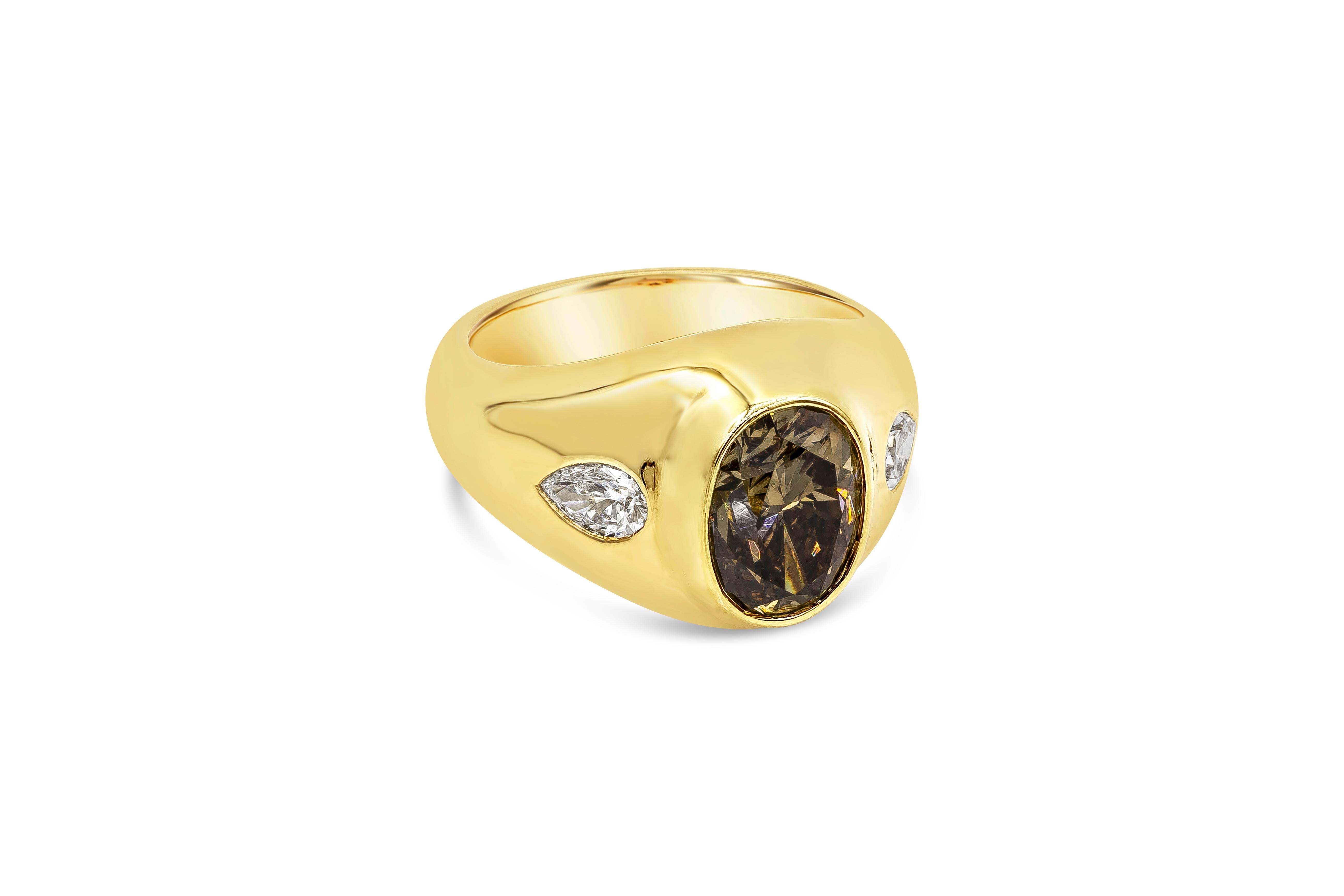 A unique gypsy style ring featuring a GIA Certified Oval Cut Fancy Dark Yellowish Brown color center stone weighing 3.01 carat, Set in a domed setting accented with two brilliant pear shape diamonds weighing 0.50 carats total. Made in 18K yellow