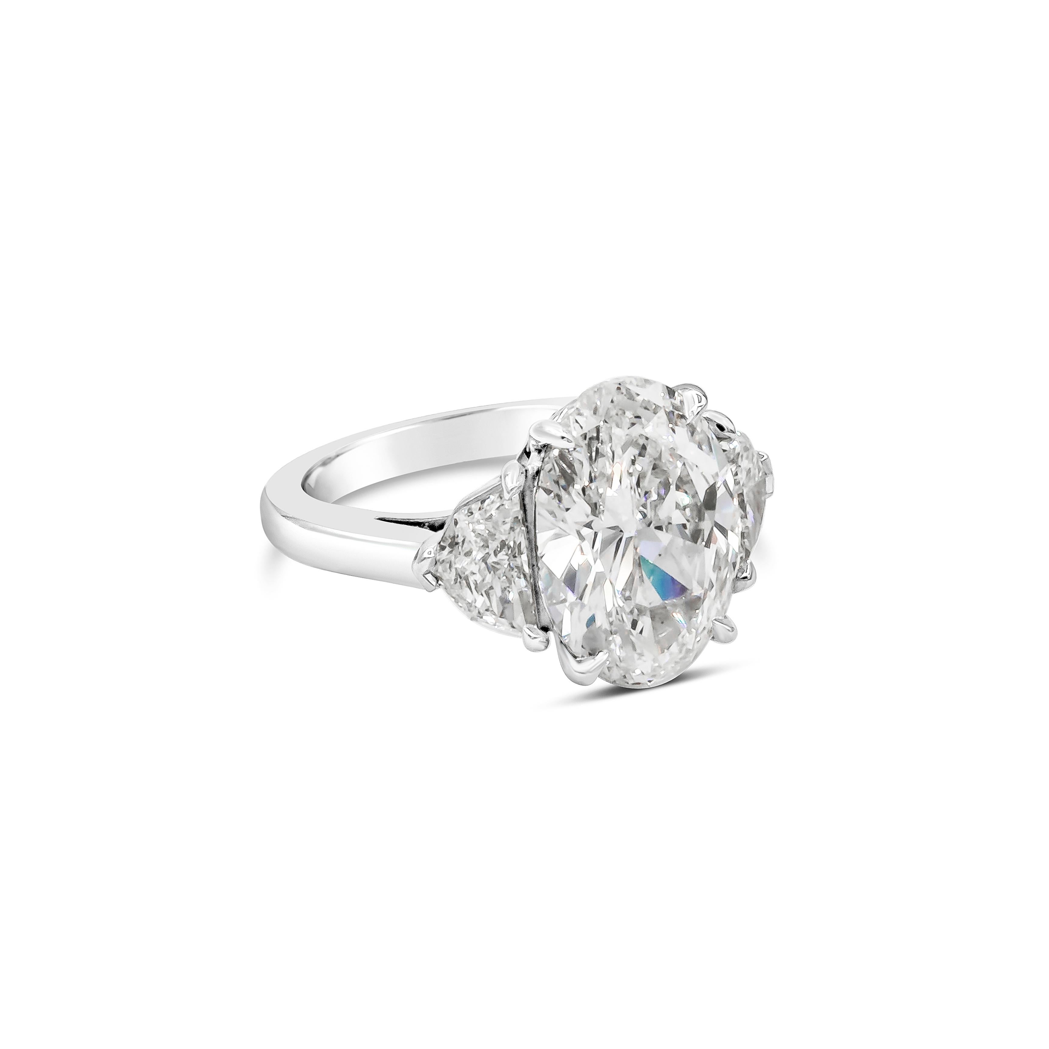 A chic engagement ring style showcasing a 5.04 carat oval cut diamond certified by GIA as I color, SI1 clarity. Flanking the center stone are two brilliant epaulette diamonds weighing 0.92 carats total, set in a polished platinum mounting.

Style