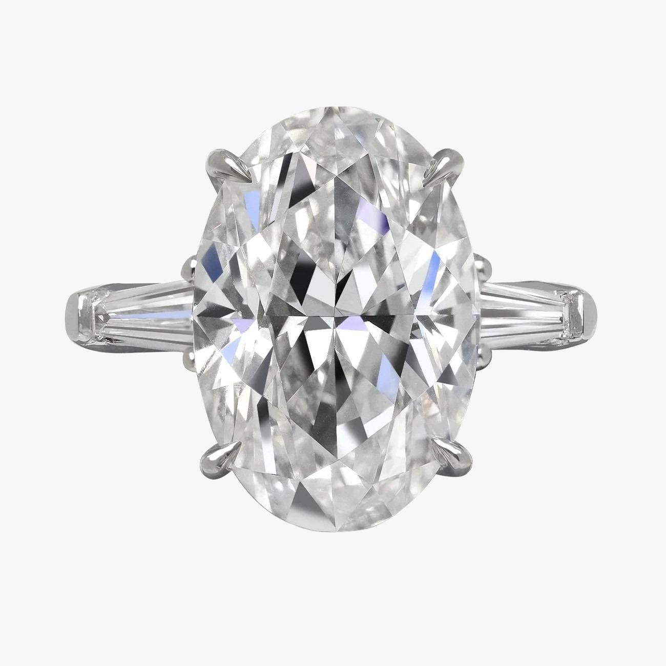 Elevate your elegance with this stunning GIA Certified Oval Diamond 3 Carat Ring, enhanced with tapered baguette diamonds. At its center, a breathtaking oval-cut diamond, certified by the esteemed Gemological Institute of America (GIA), takes the