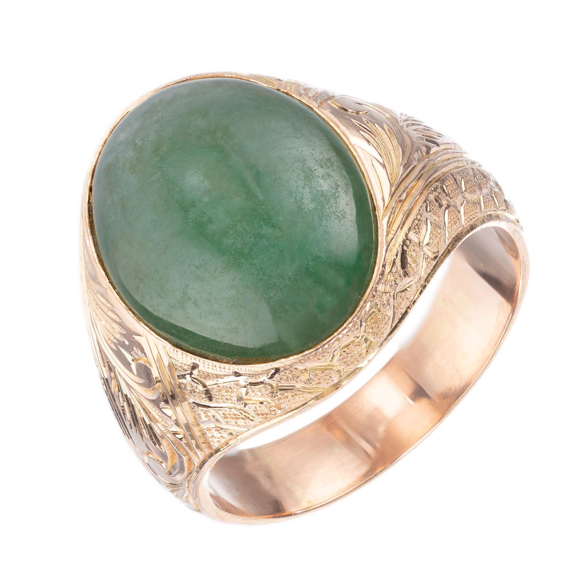 GIA certified Oval jadeite jade center stone in a handmade hand engraved 14k rose gold setting.  

1 oval green translucent Jadeite Jade, GIA Certificate # 1186037918
Size 8.75 and sizable
14k rose gold 
Stamped: 585
8.2 grams
Width at top: