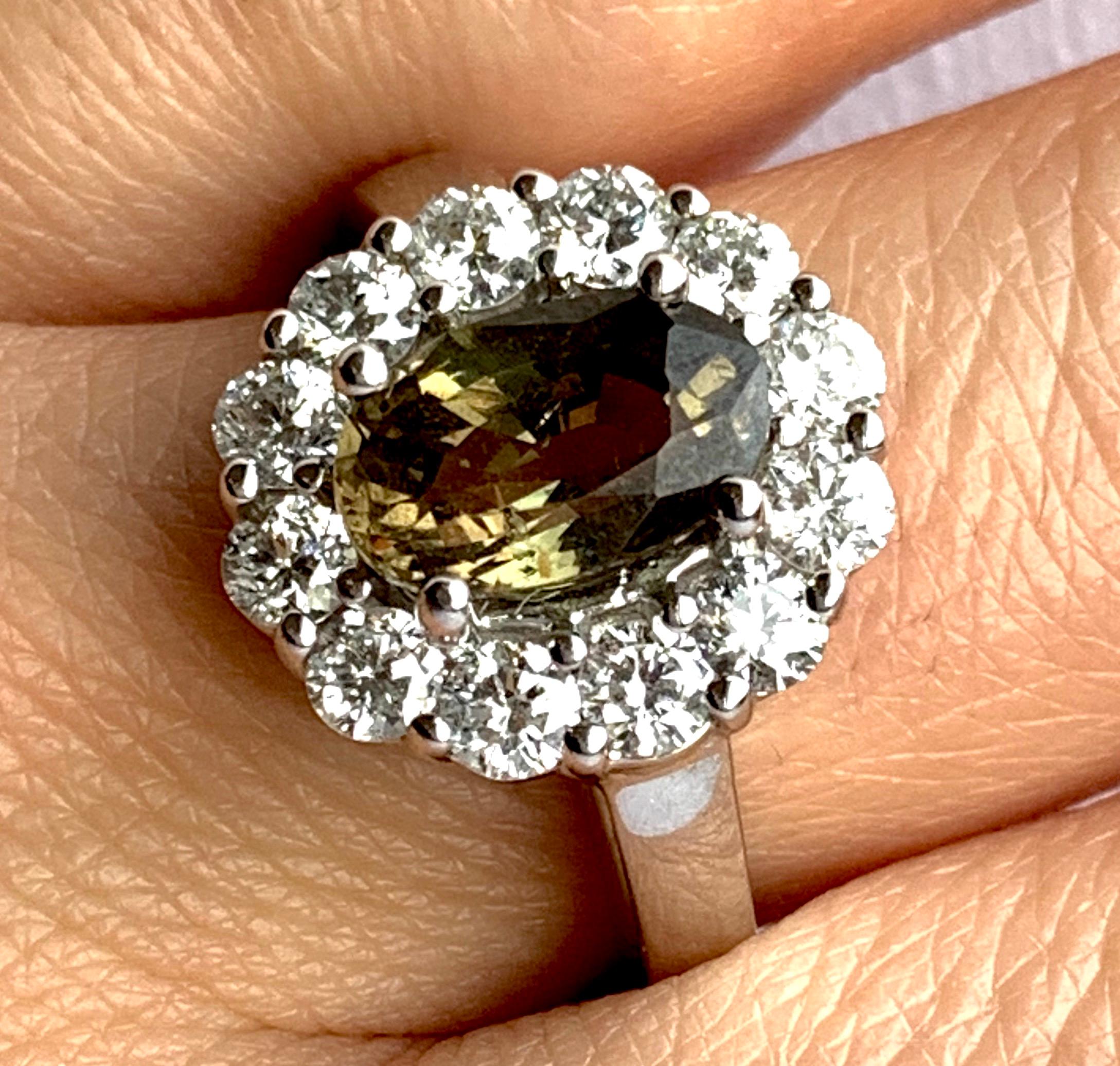 This GIA Certified Alexandrite is truly a special stone. Changing color in light, the 2.23 carat stone ranges from yellowish green to brown-yellow. Surrounded by petals of brilliant white diamonds totaling 0.61 carats, this is a piece you don't want
