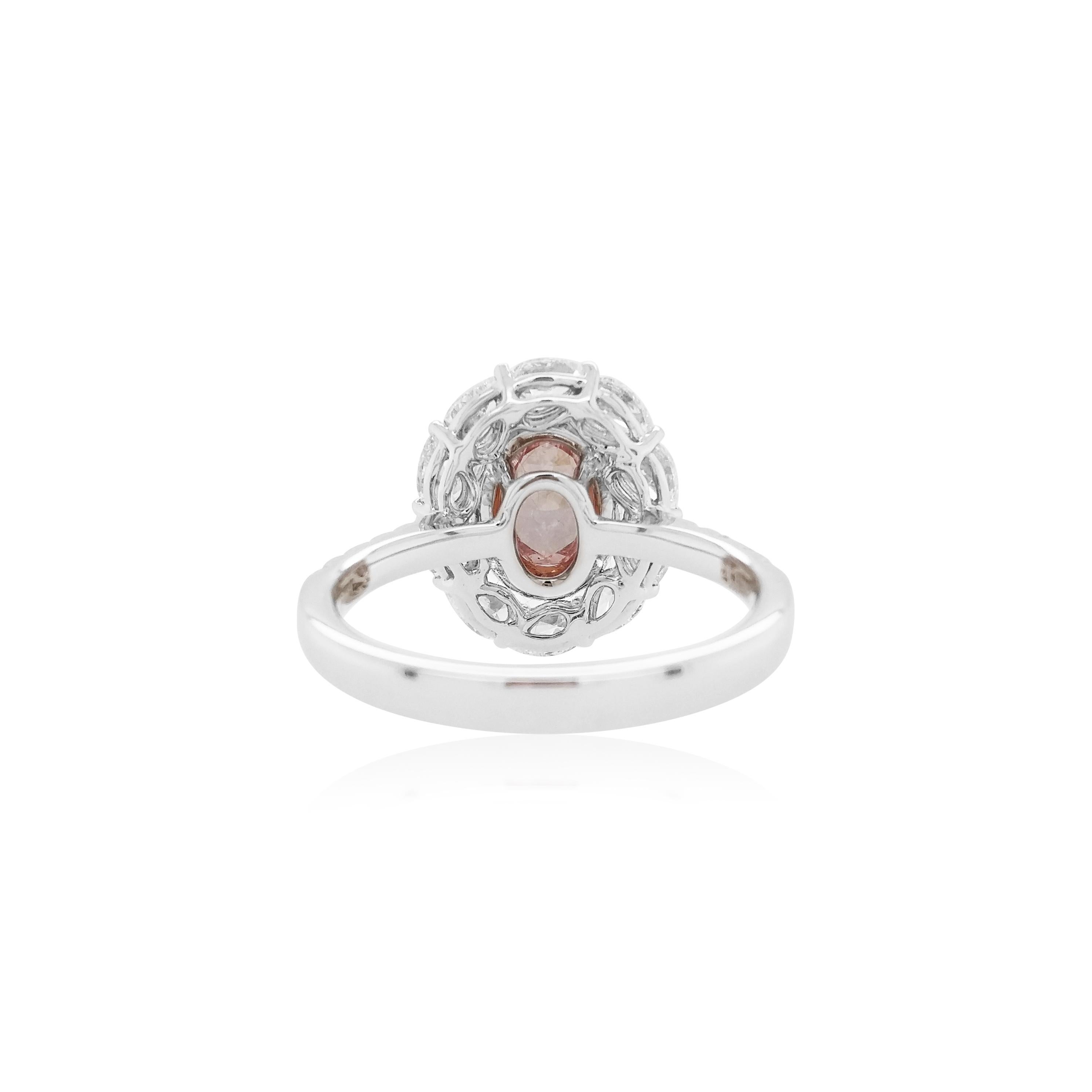 Un lussuoso pezzo da esposizione con uno splendido diamante Natural Fancy Pink Diamond dal taglio ovale certificato GIA come pezzo centrale, circondato da scintillanti diamanti rosa taglio brillante e diamanti bianchi a forma di pera incastonati in