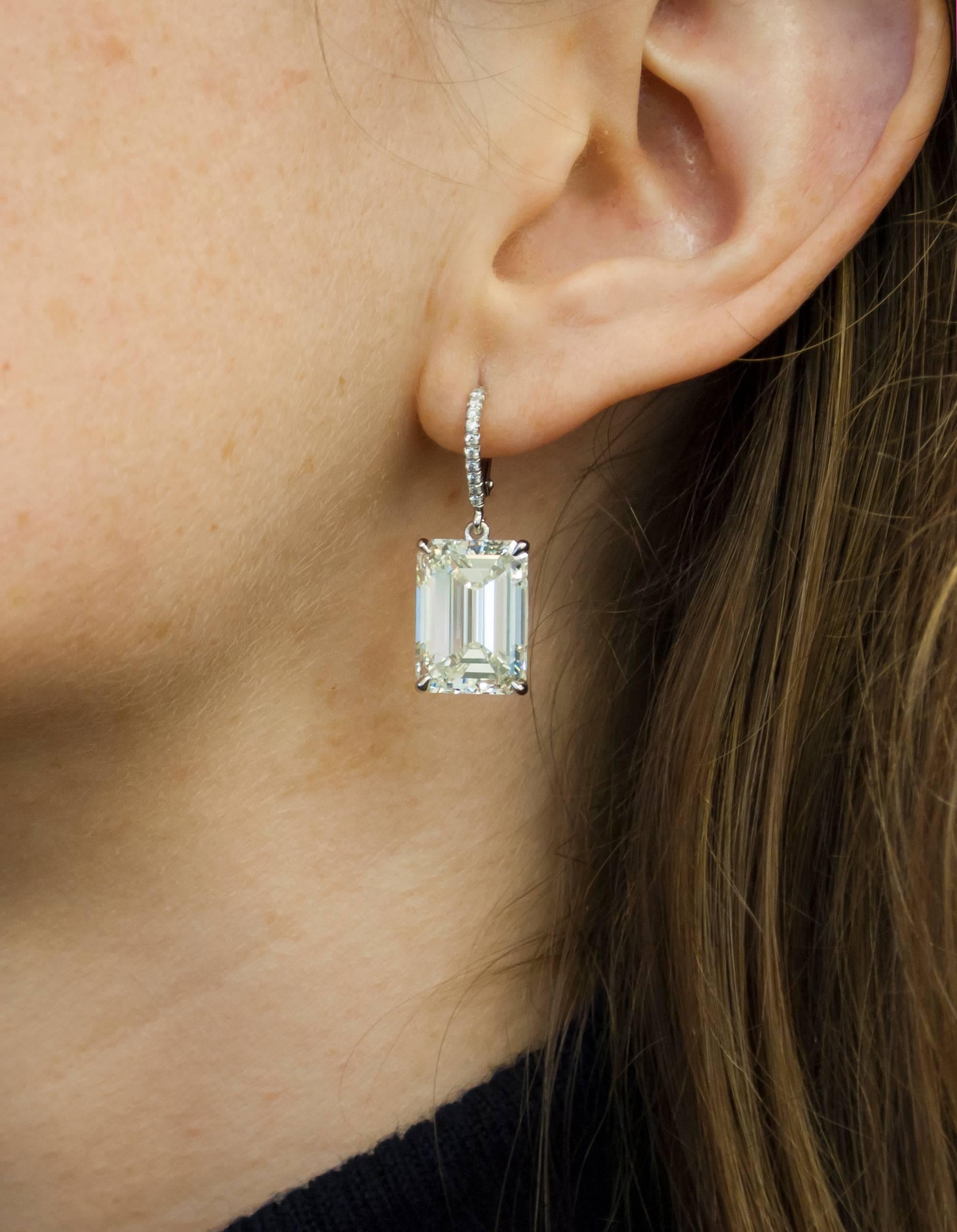 This amazing pair of emerald cut lever-back earrings by J. Birnbach features emerald cut diamonds weighing 10.03 carats and 10.08 carats each. They are set on a platinum mounting with pave diamonds down the wire. The two diamonds are certified by