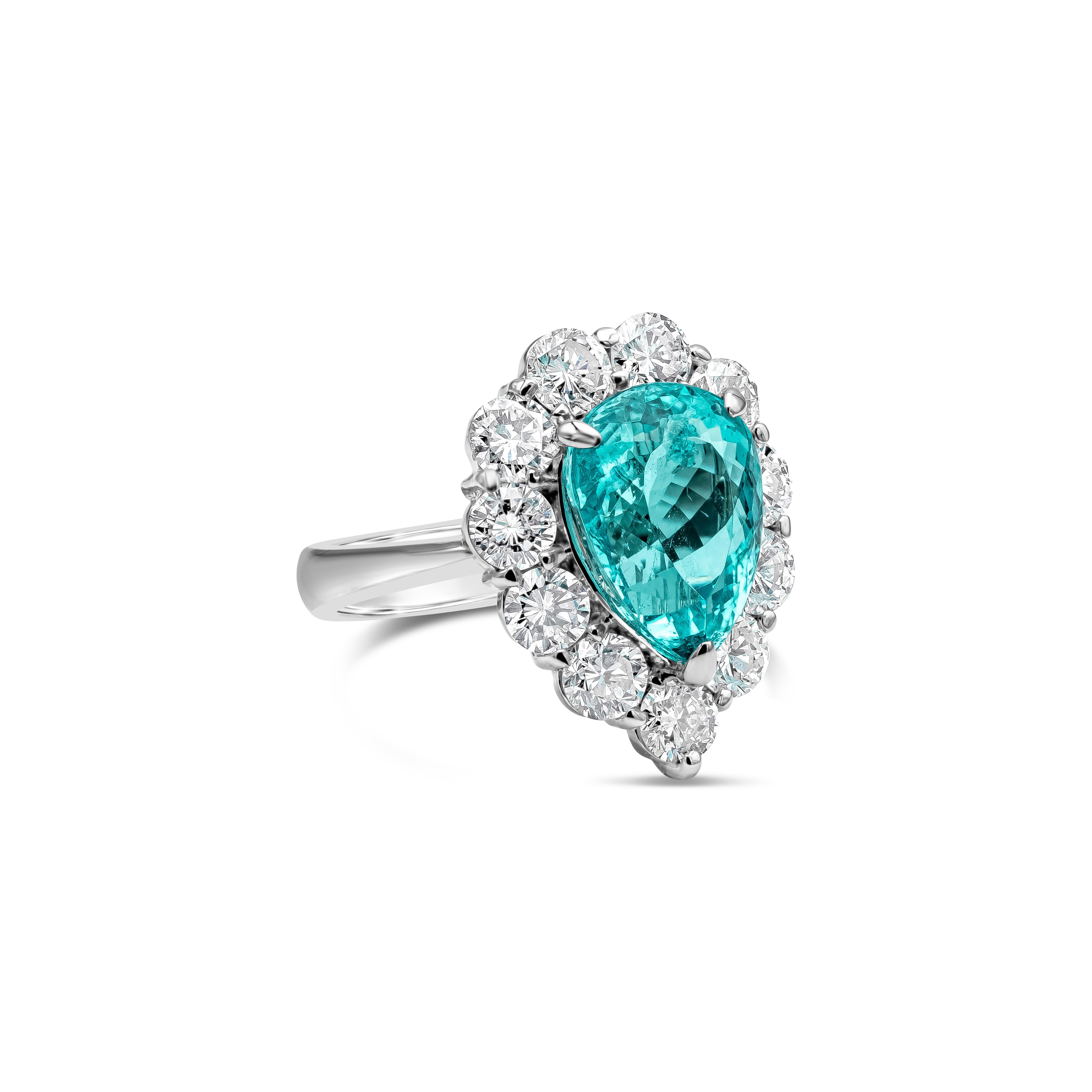 This beautiful ring showcases a GIA Certified pear shape indicolite blue-green Paraiba tourmaline center stone weighing 4.74 carat. Surrounded by brilliant round shape diamonds weighing 2.26 carats total, D-E Color and SI in Clarity. Made in