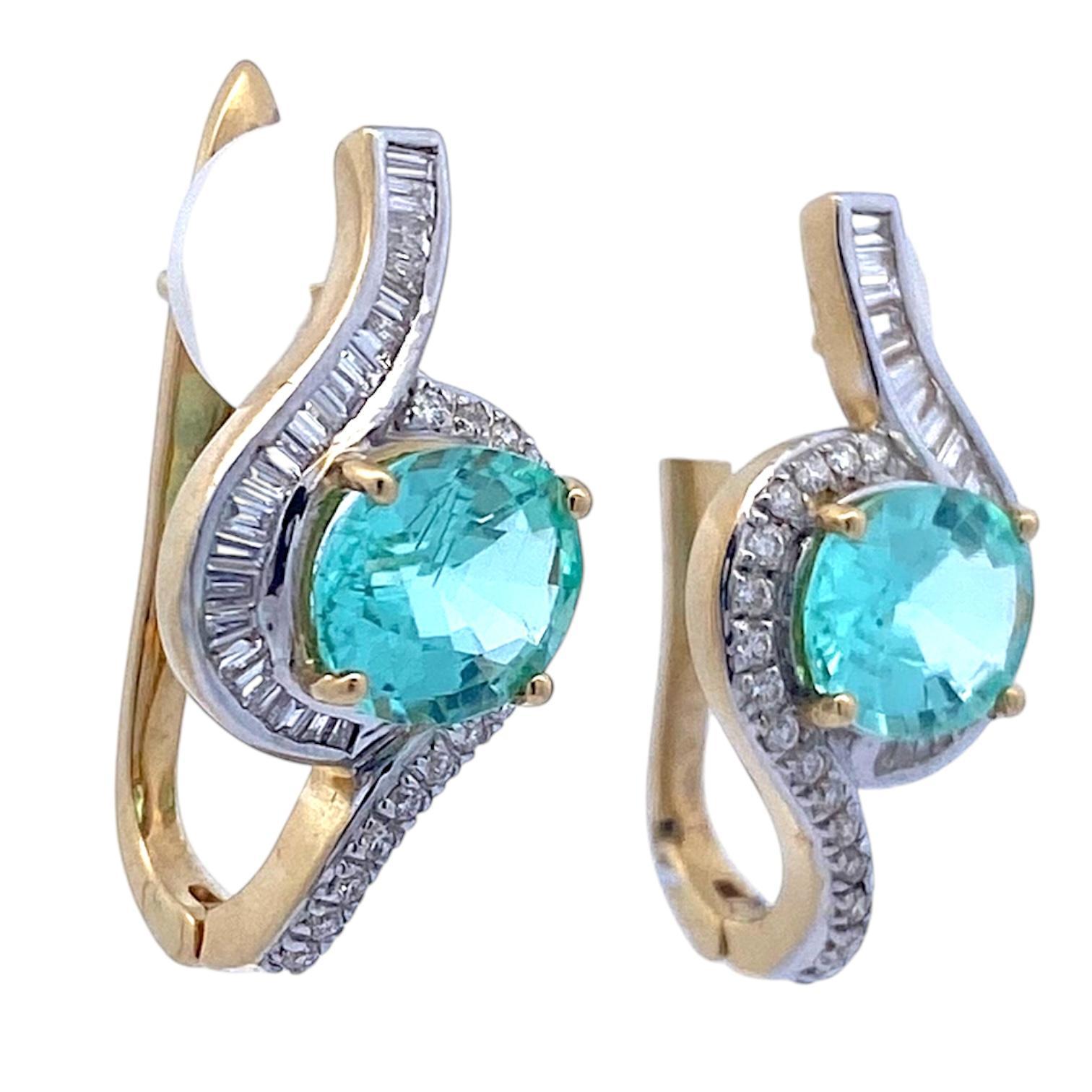 18K yellow gold drop earrings featuring GIA certified oval blue Paraiba Tourmalines surrounded by baguette and round brilliant cut white diamonds, 1.0 carat total, with VS2-SI1 clarity and G-H color grade. Bright polish finish with rhodium