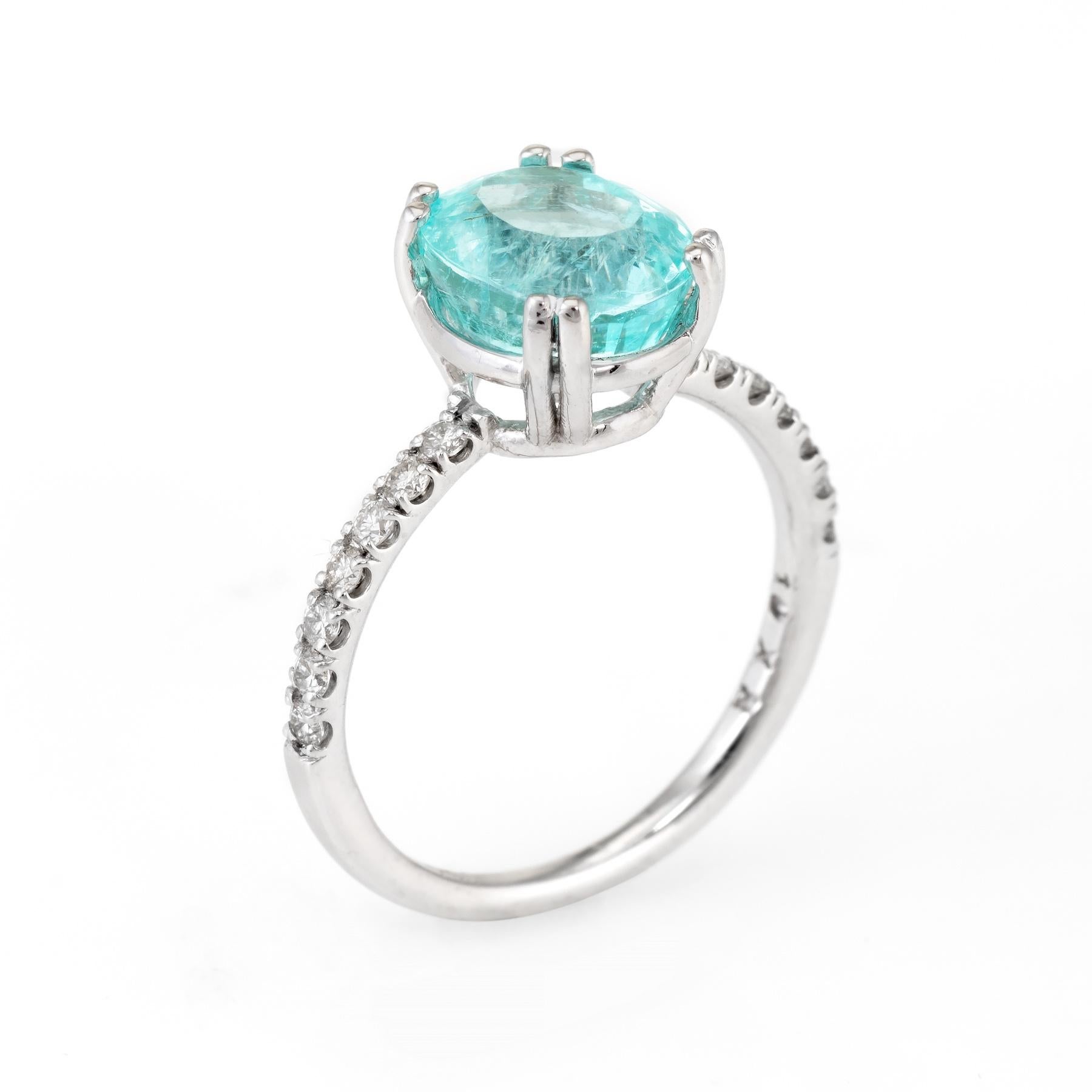 Finely detailed estate ring, crafted in 14 karat white gold. 

GIA certified Paraiba tourmaline measures 9.73 x 8.12 x 6.15mm (3.34 carats). The oval shaped stone is transparent with a green blue color. The origin of the tourmaline is Mozambique.