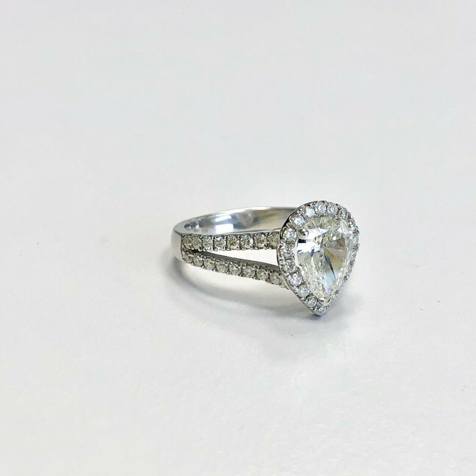 This is a beautiful 14k white gold diamond ring Split Shank with Pear Shape center stone of 1.19ct J color and clarity of VVS2 graded by GIA has a 40pcs small side stones with estimated weight of .55ct H color and clarity of VS1. The current ring
