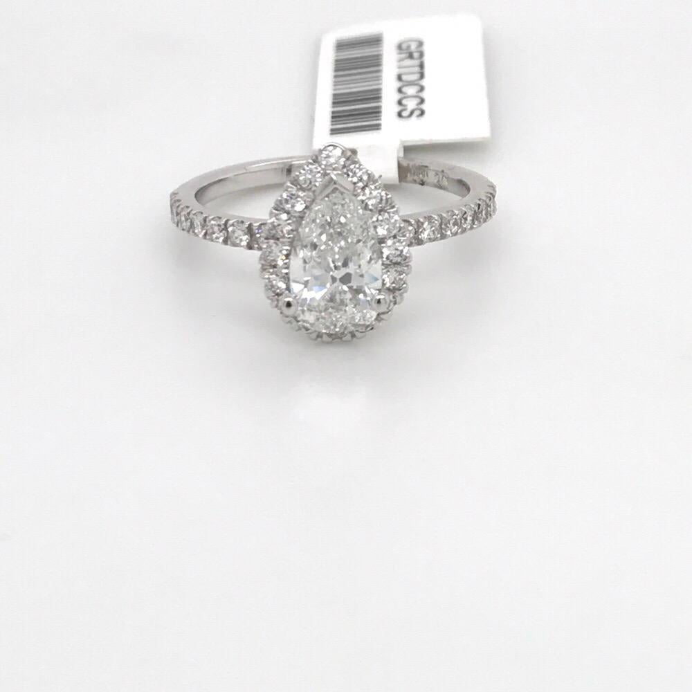 14K White gold engagement ring featuring one pear cut diamond weighing 1.01 carats flanked with a diamond halo setting weighing 0.38 carats.
GIA Certfied E, SI1