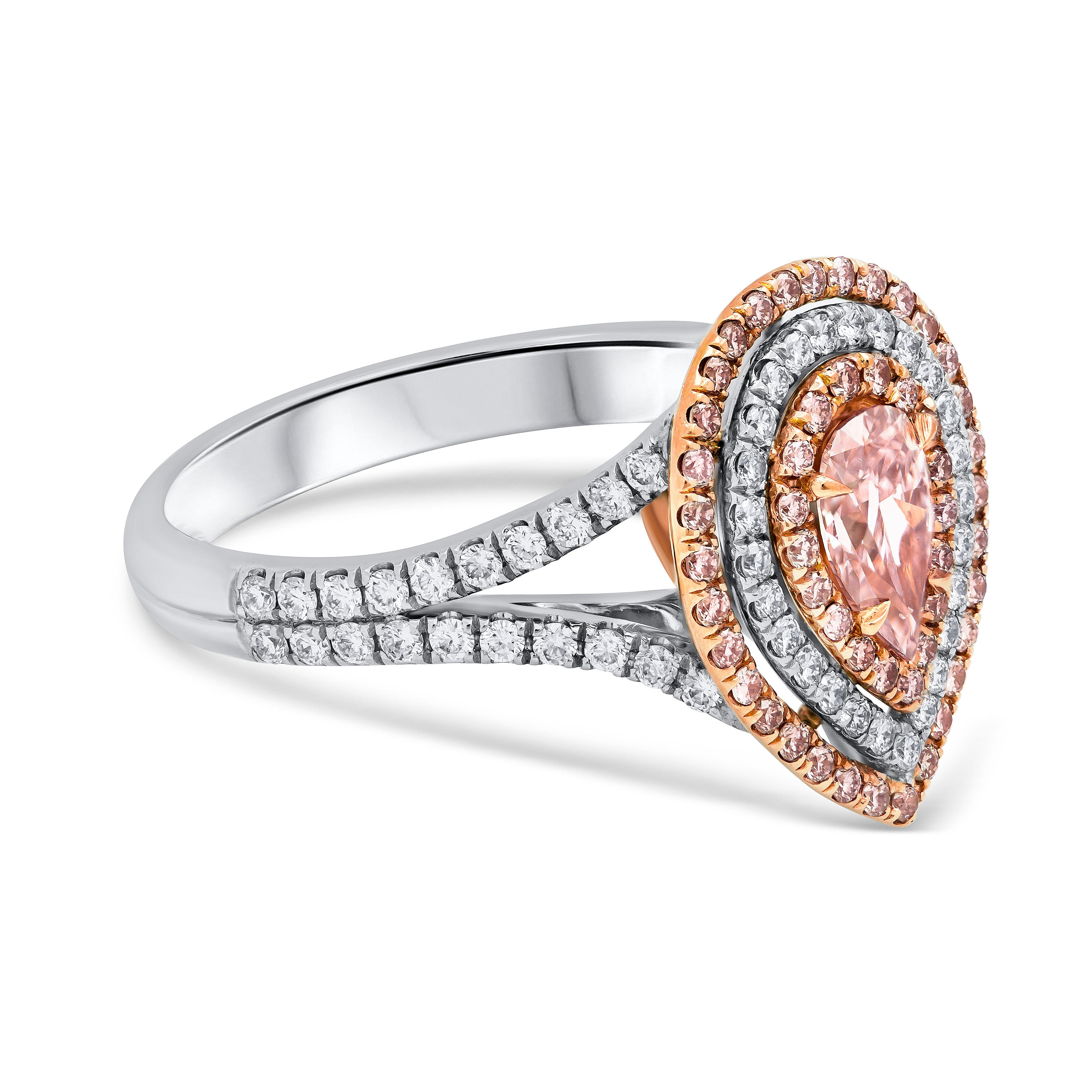 Well crafted and rare engagement ring featuring a colorful and vibrant 0.47 carat pink diamond that GIA certified as fancy intense purplish pink color, SI2 clarity, set in a four prong 18k rose gold basket. Center stone is surrounded by three rows