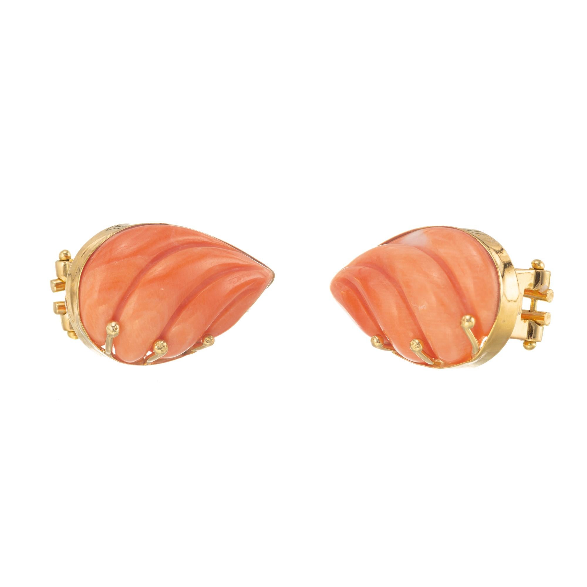 Vintage pink orange carved pear shape coral earrings. GIA certified natural untreated croal clip post earrings

2 carved pink orange pear shape coral GIA Certificate # 5202120585
18k yellow gold 
Stamped: 750
9.0 grams
Top to bottom: 20mm or 13/16