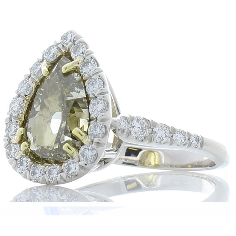 At center is a 4.00 carat, pear shaped, GIA certified, fancy dark gray-greenish yellow diamond measuring 10.75 x 8.04 x 5.83 mm. This diamond is natural and it's large. The color is perfect natural cinnamon, not the color of the store-bought type.