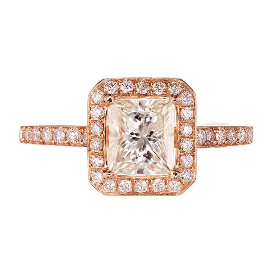 Experience the pinnacle of romance with the GIA Certified Peter Suchy 1.00ct Diamond halo rose gold engagement ring. This exquisite piece is more than a ring. The princess cut 1.00 carat center diamond, is framed by a halo of round ideal cut