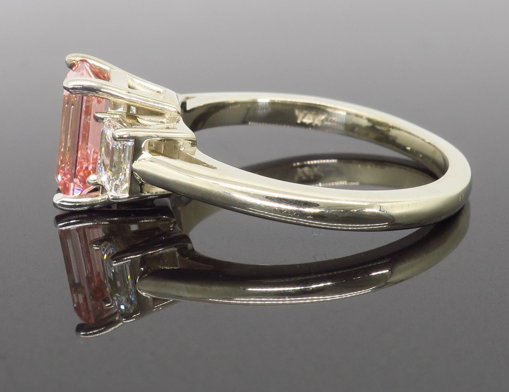 pink three stone emerald cut engagement ring