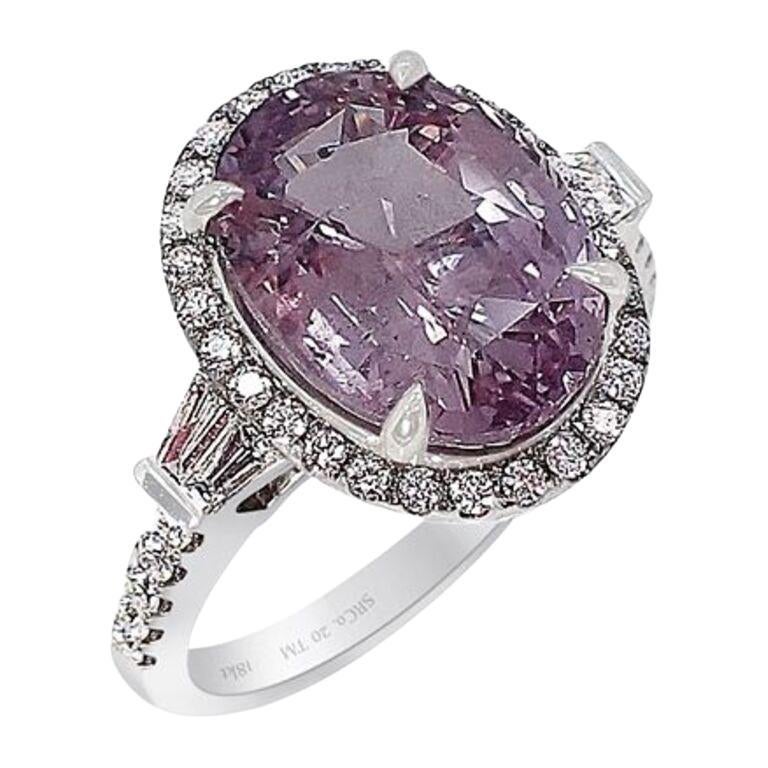 New 18kt White gold custom sapphire ring set with oval cut untreated natural pink sapphire, measuring 12.12 x 9.23 x 5.59 mm with a carat weight of 5.52 ct. Type II, Medium-light, moderately strong, slightly purplish red color GIA slpR 4/4.  Set