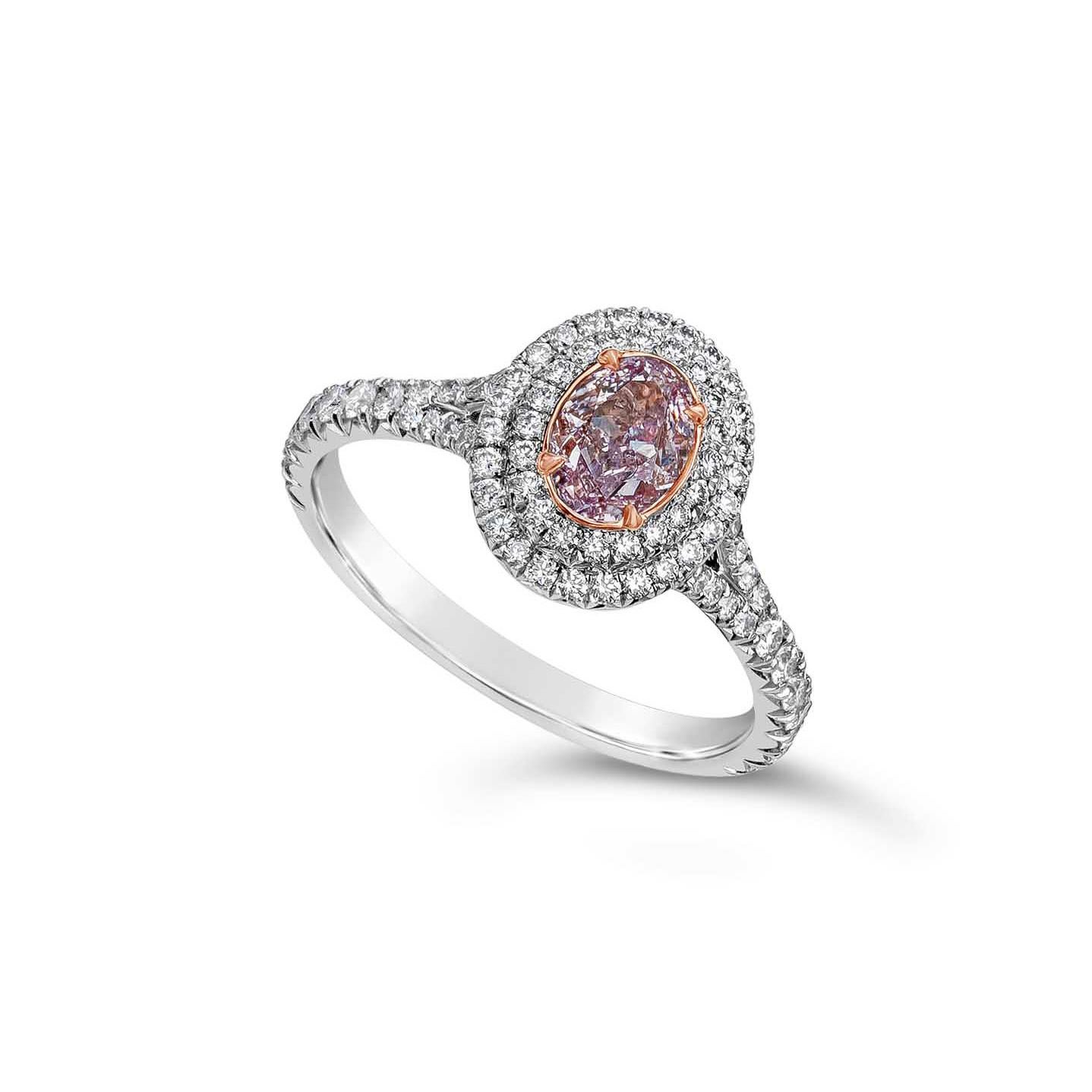 Features a rare 0.63 carat oval cut diamond certified by GIA as Fancy Light Pinkish Purple color, VS2 clarity. Surrounding the center are two rows of round brilliant diamonds set in a split shank setting. Accent diamonds weigh 0.58 carats total and