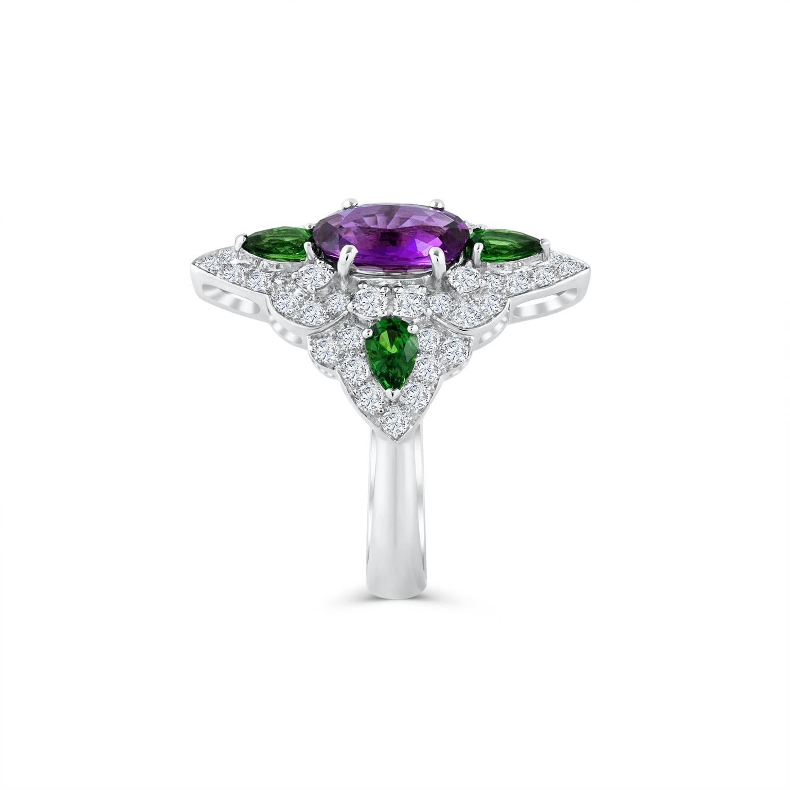 Add color to your style with this fashionable ring by Roman Malakov. Showcases a 1.90 carat GIA certified oval shape pinkish purple sapphire accented by 4 pear shaped green tsavorite garnets weighing 0.75 carats total. Finished with sparkling