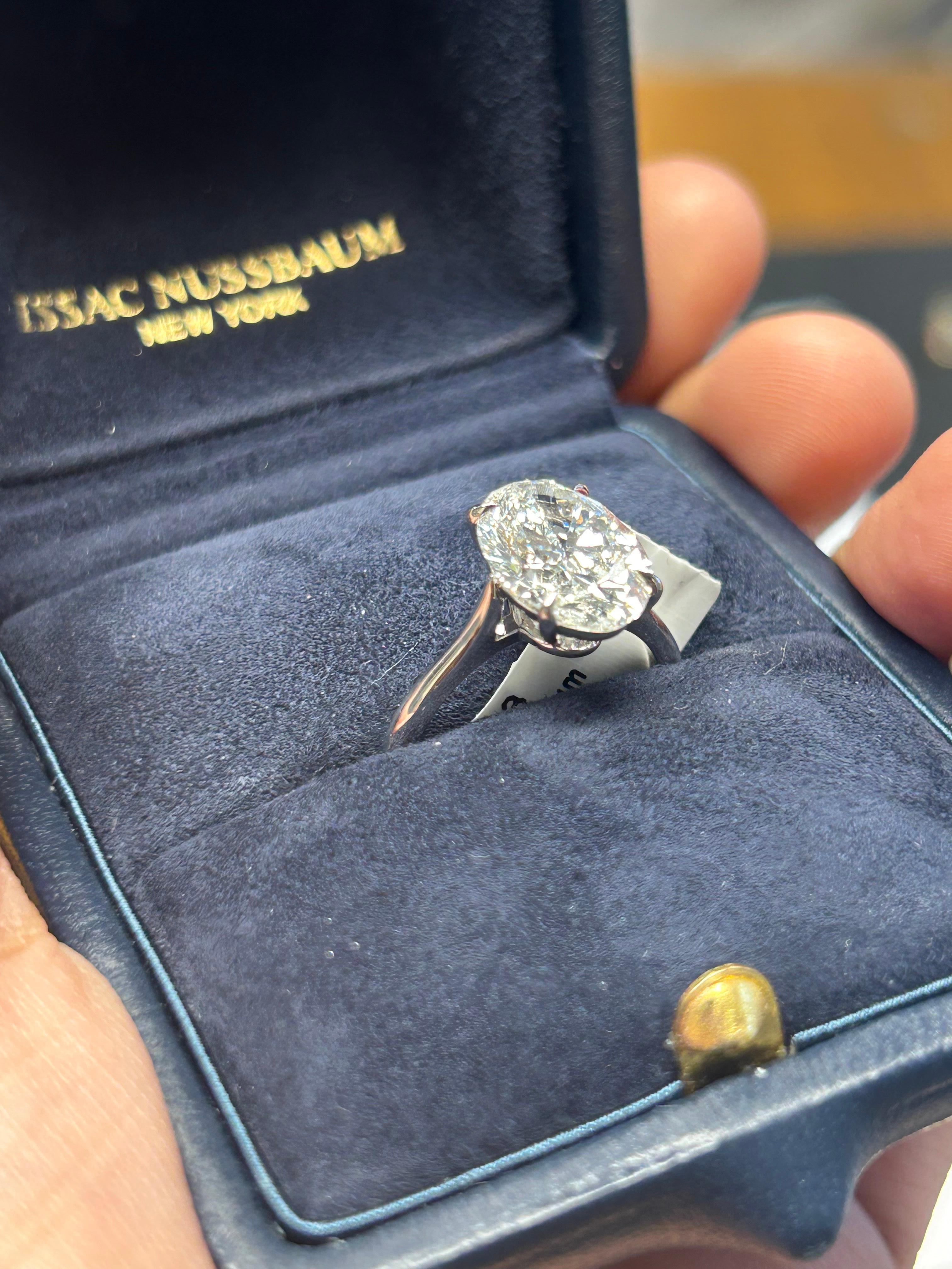 Introducing the stunning natural GIA Certified Platinum 4.05 carat oval diamond engagement ring. Imagine the soft, romantic shape of the oval diamond, expertly cut to maximize brilliance and sparkle. Its unique silhouette elongates the finger,