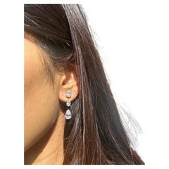 Issac Nussbaum Platinum 5.73 Carat Oval and Pear Shape Diamond Earrings.