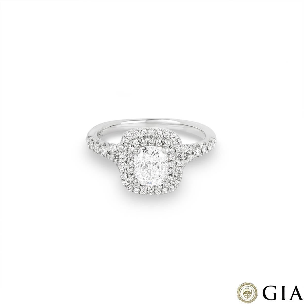 An stunning platinum diamond engagement ring. The ring features a cushion cut diamond set to the centre of a double halo mount weighing 1.01ct, D colour and SI2 clarity. Further complementing the central diamond are 72 round brilliant cut diamonds