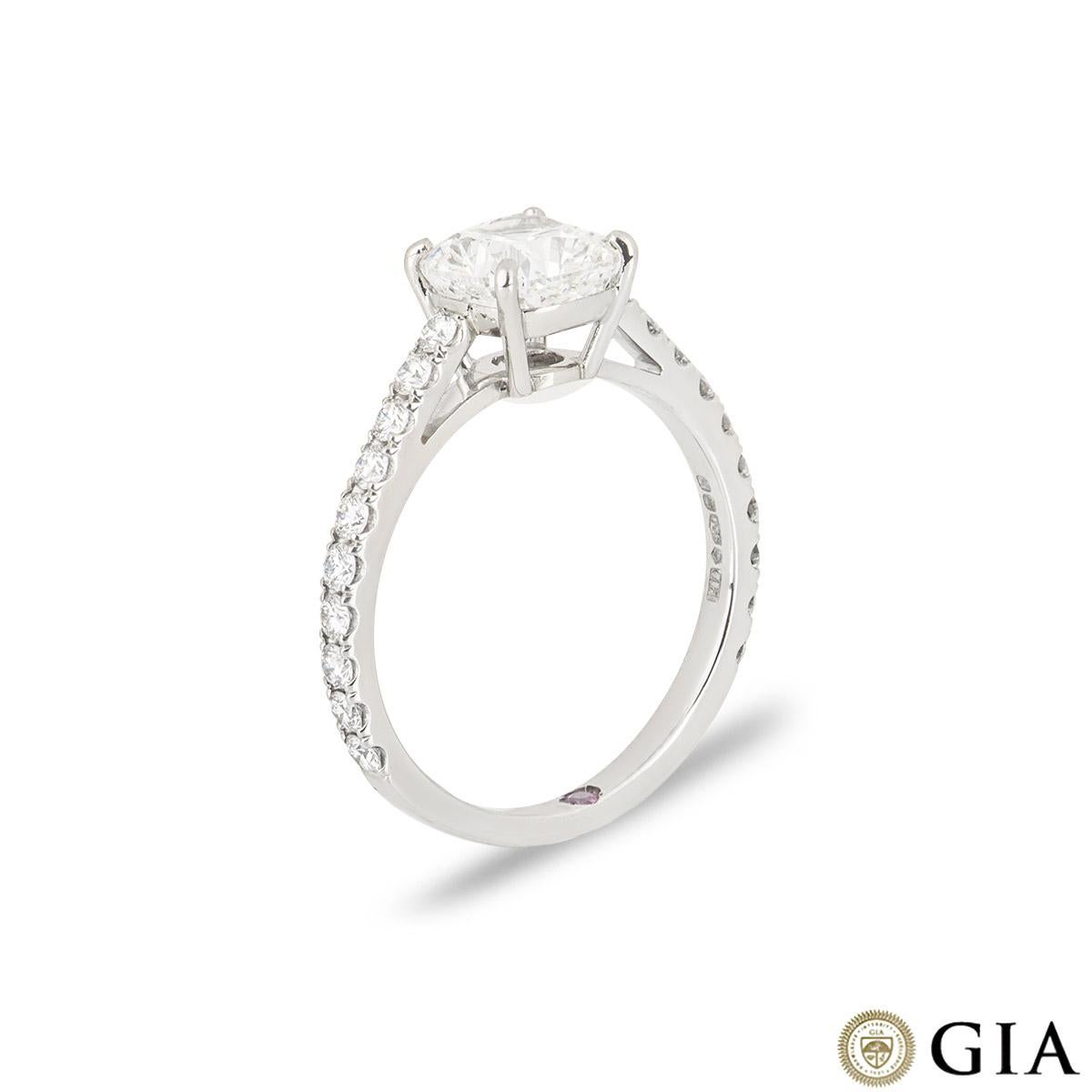 A stunning platinum cushion cut diamond engagement ring. The ring features a cushion cut diamond set to the centre in a 4 claw setting weighing 1.55ct, G colour, and VVS1 clarity. The central diamond is complemented by 20 round brilliant cut
