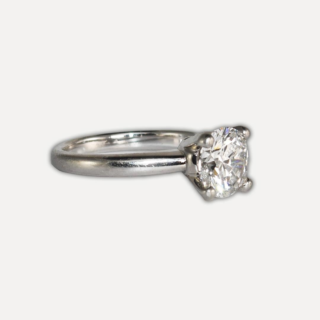 Platinum and diamond solitaire ring.
Tests platinum and weighs 4.9 grams gross weight.
The diamond is a round brilliant cut, 1.51 carats, F color, Si1 clarity, and symmetry very good.
The GIA grading report number is 12147650.
Comes with an original